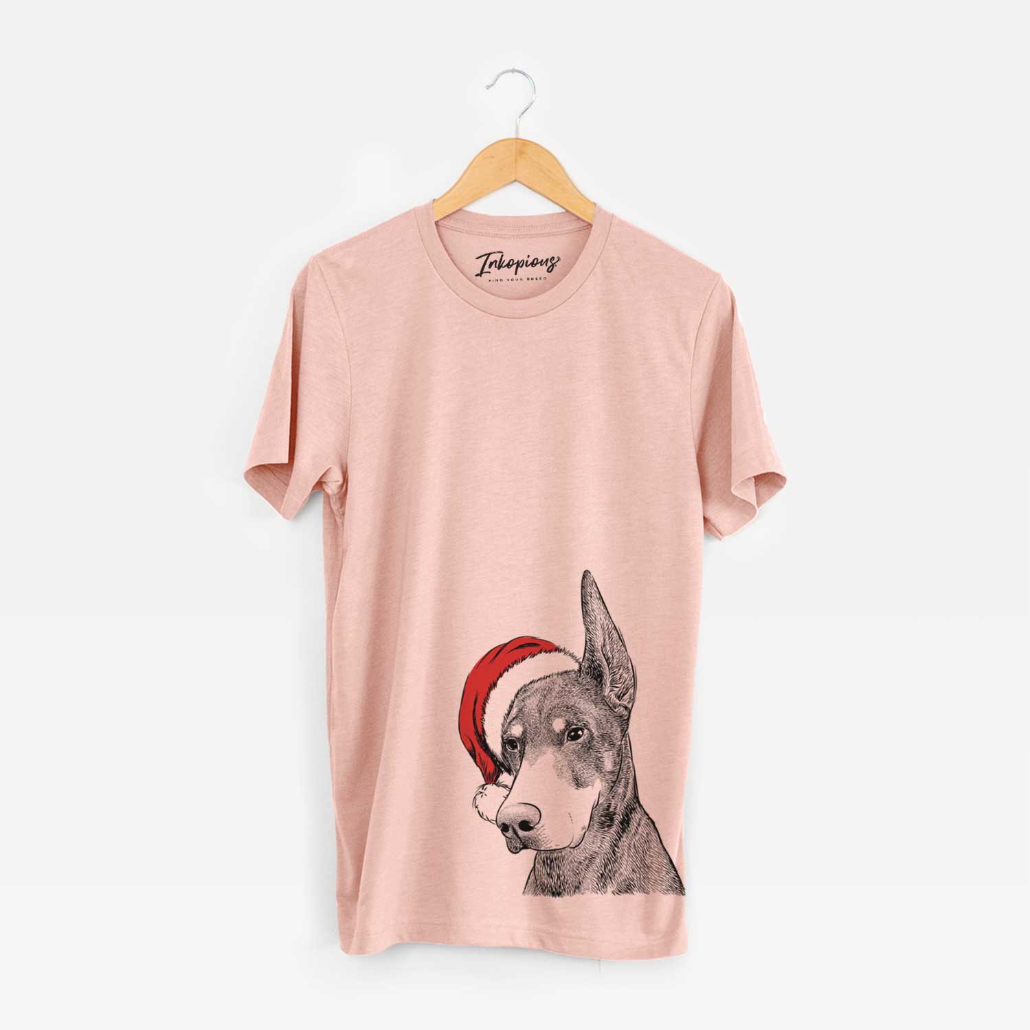 Hand-drawn sketch of Sunny the Doberman Pinscher wearing a Santa hat on a Peach Unisex crewneck