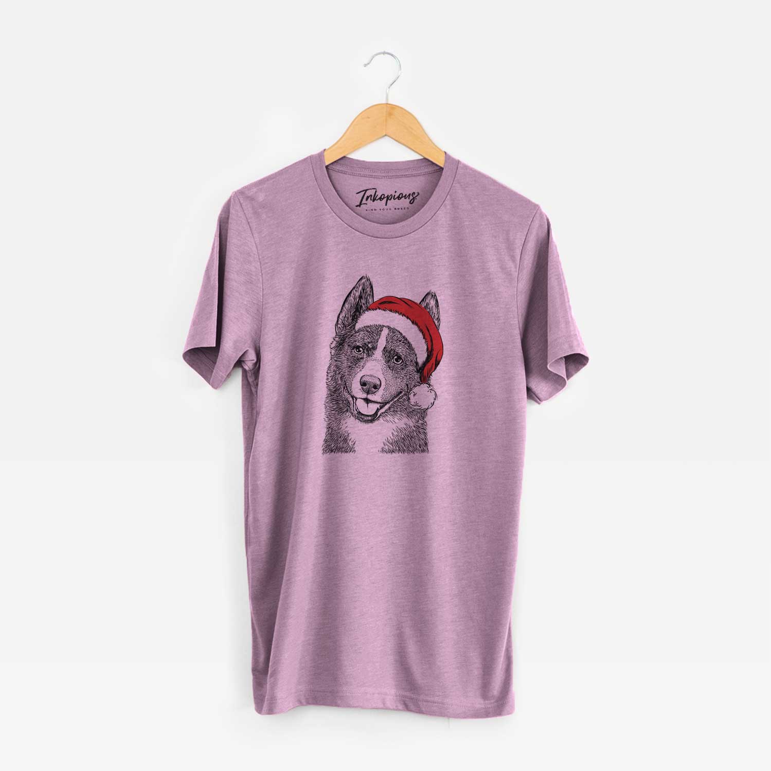 Hand-drawn sketch of Tosca the Karelian Bear Dog wearing a Santa hat on an Orchid Unisex crewneck