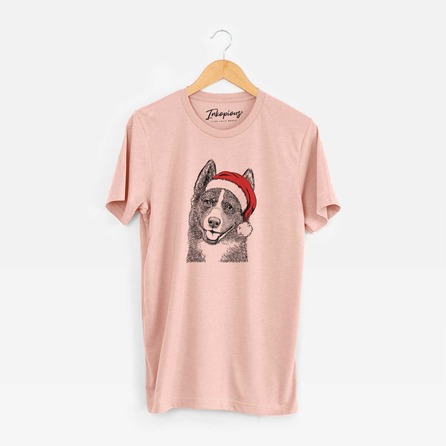 Hand-drawn sketch of Tosca the Karelian Bear Dog wearing a Santa hat on a Peach Unisex crewneck