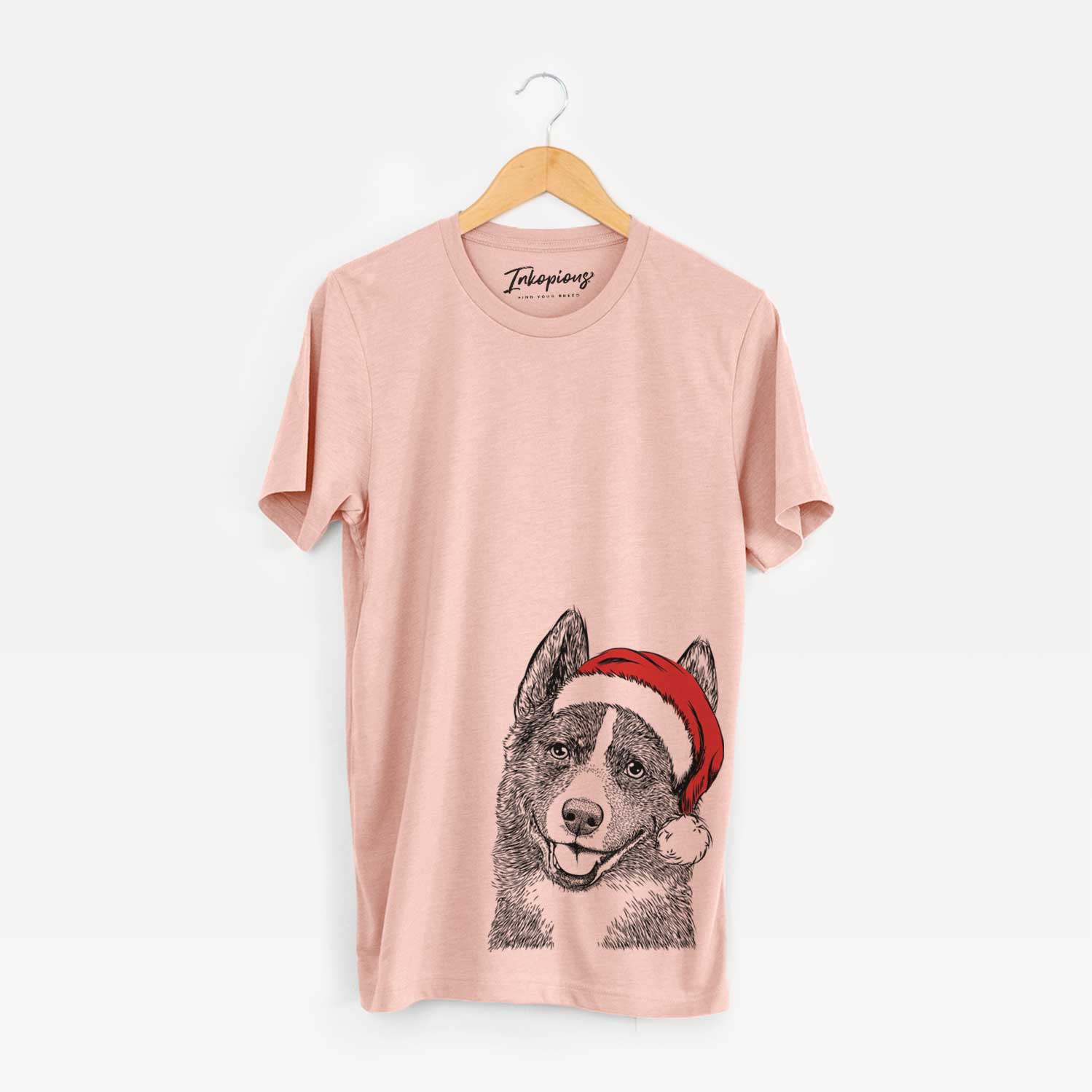 Hand-drawn sketch of Tosca the Karelian Bear Dog wearing a Santa hat on a Peach Unisex crewneck