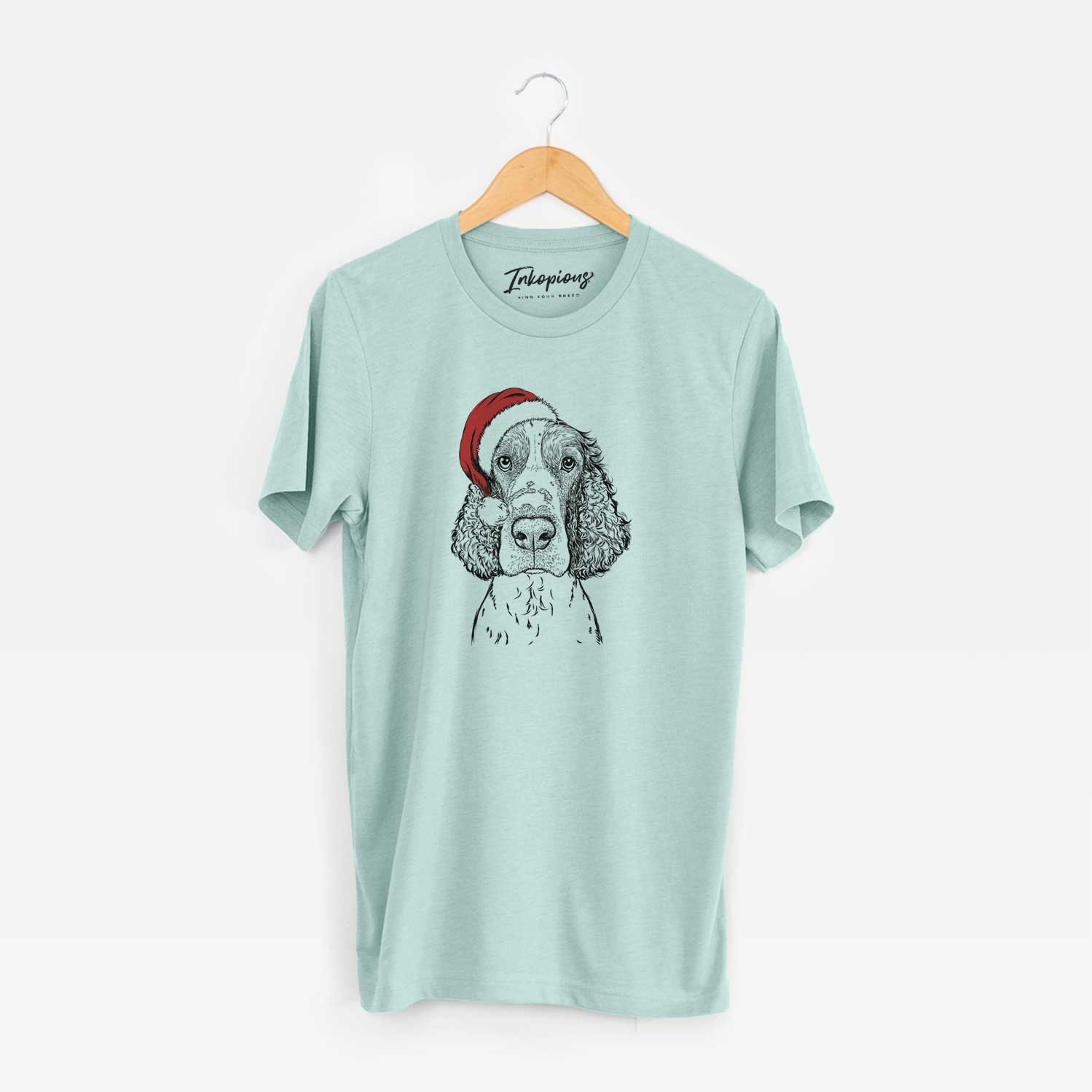 Hand-drawn sketch of Wilbur the English Springer Spaniel wearing a Santa hat on a Heather Sage Unisex crewneck