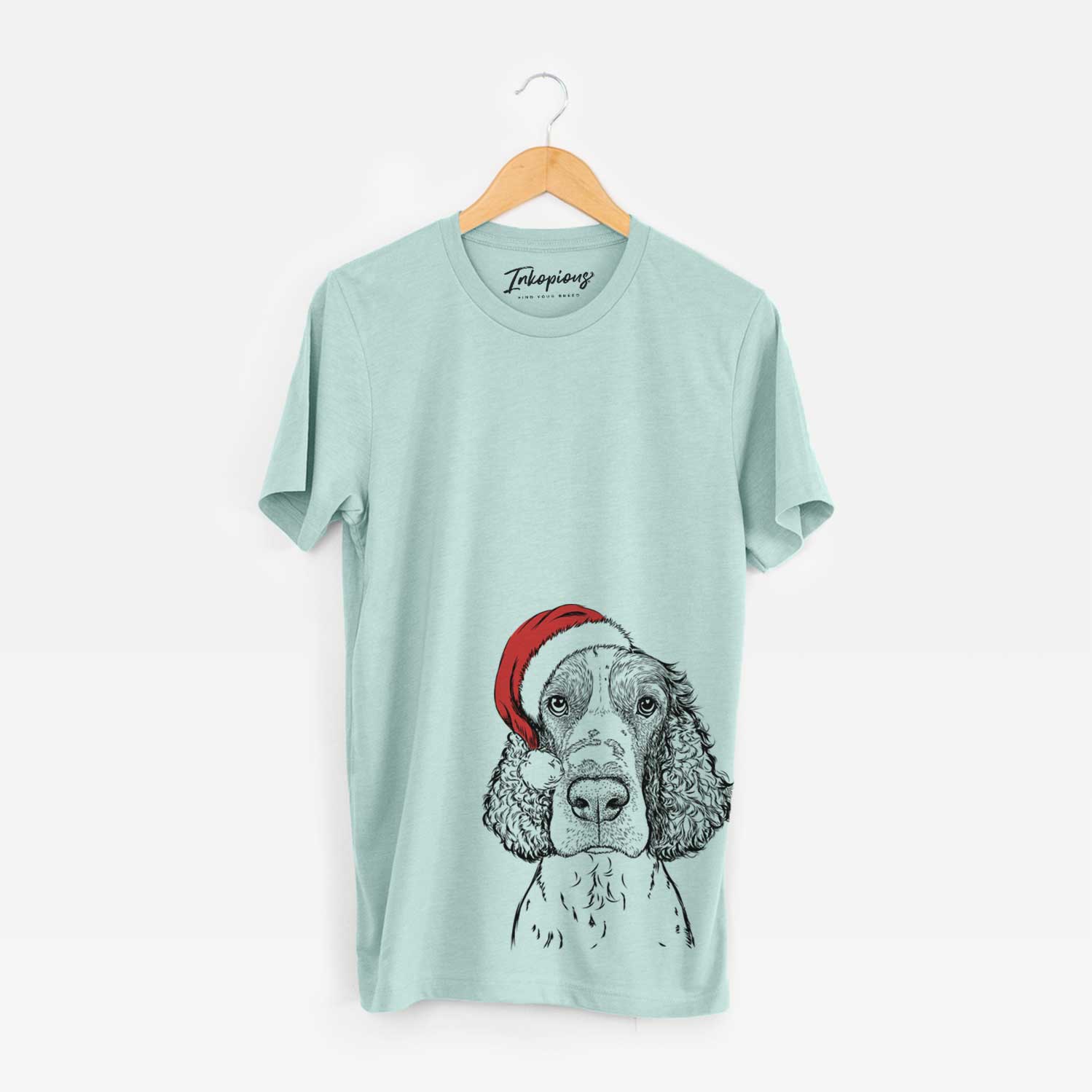 Hand-drawn sketch of Wilbur the English Springer Spaniel wearing a Santa hat on a Heather Sage Unisex crewneck