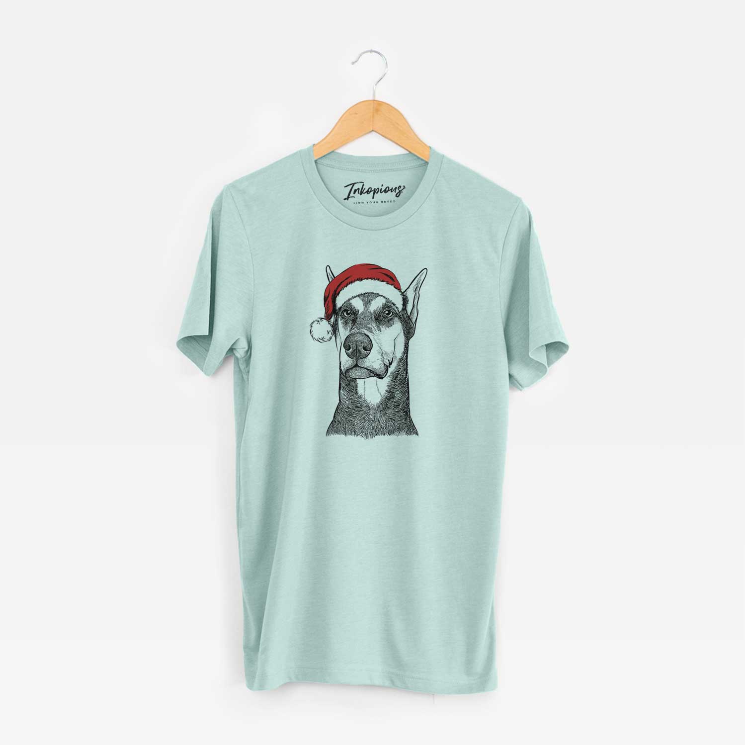 Hand-drawn sketch of Zeus the Doberman Pinscher wearing a Santa hat on a Heather Sage Unisex crewneck