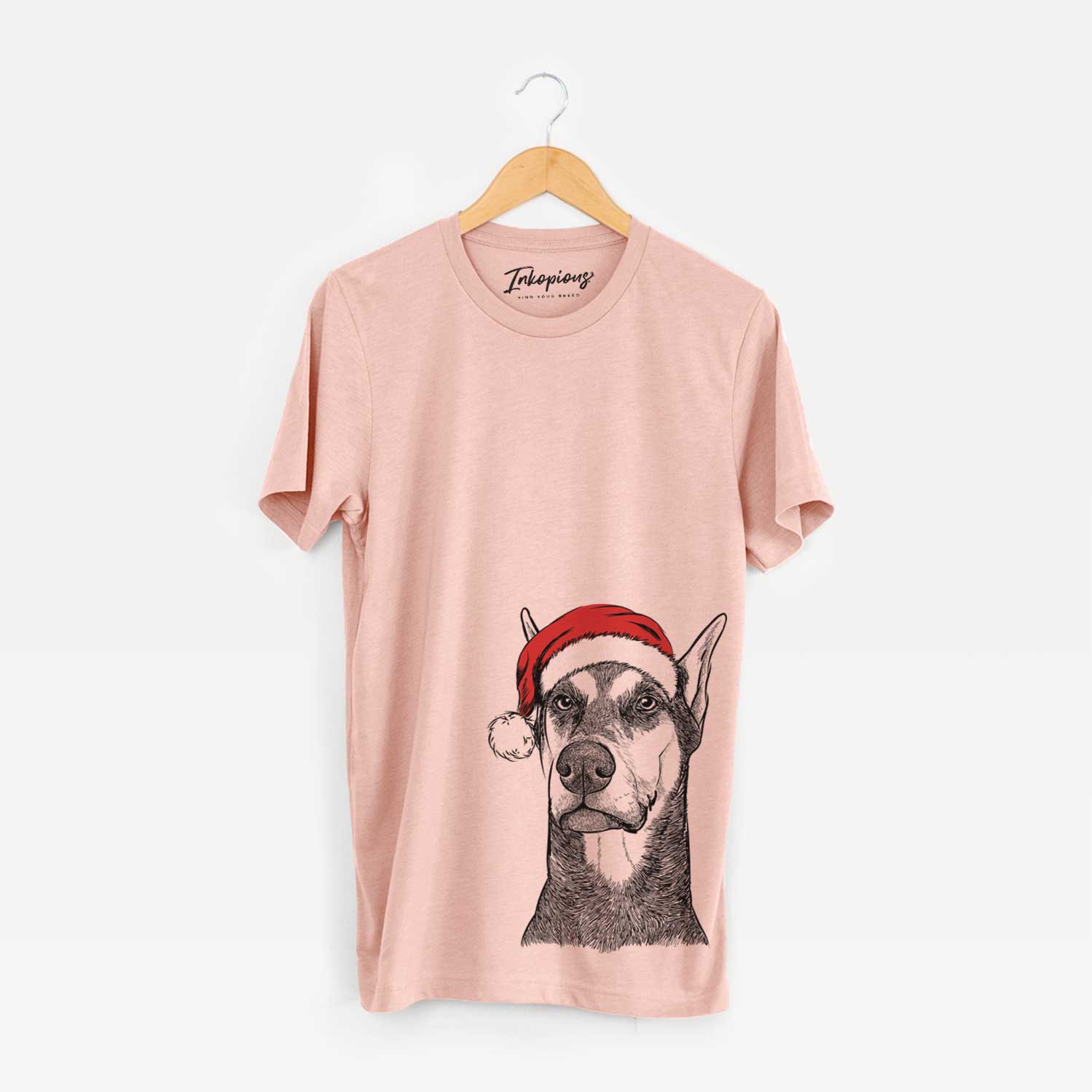 Hand-drawn sketch of Zeus the Doberman Pinscher wearing a Santa hat on a Peach Unisex crewneck