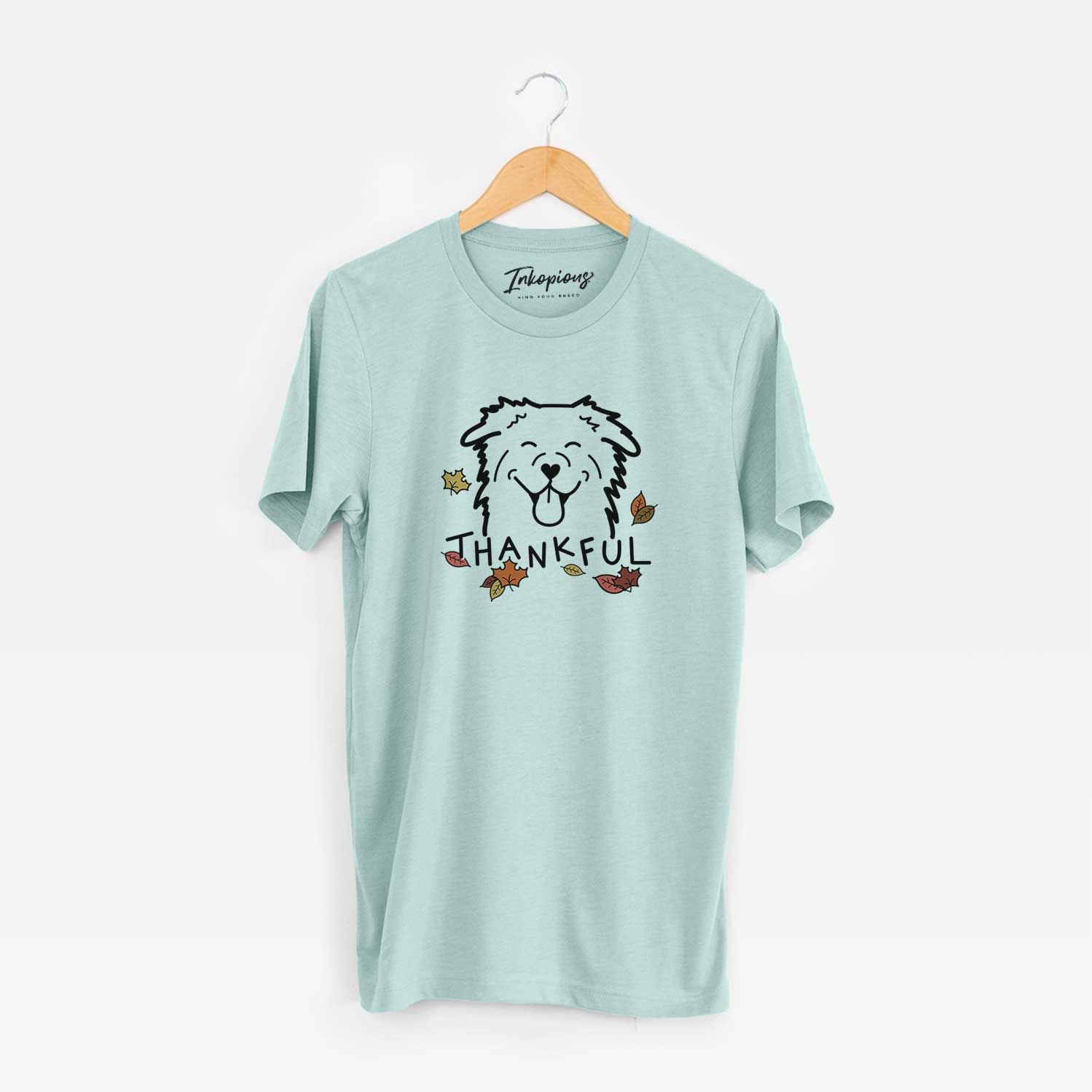 Minimalist line drawing of an Australian Shepherd with 'Thankful' lettering on a Heather Sage Unisex crewneck