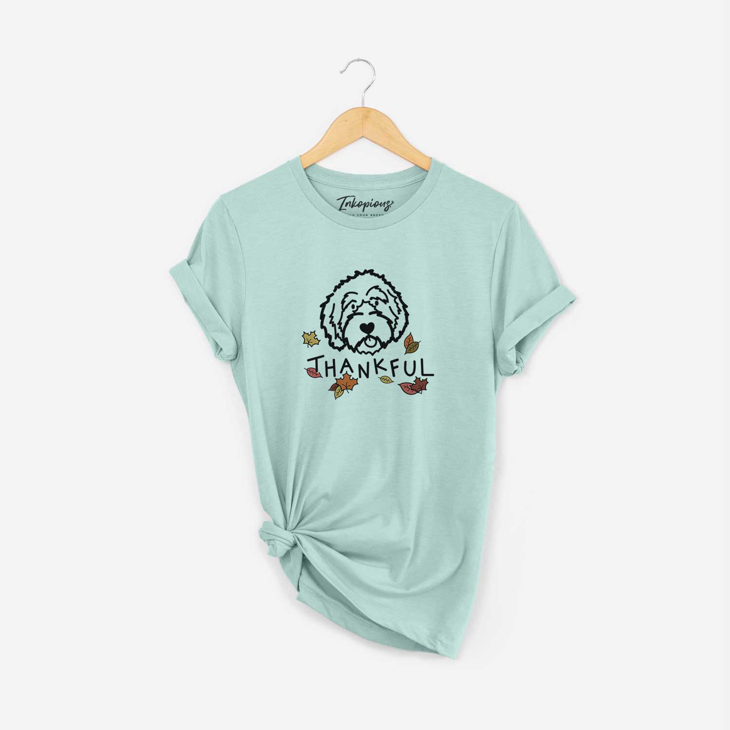 Minimalist line drawing of an Aussiedoodle with 'Thankful' lettering on a Heather Sage Unisex crewneck