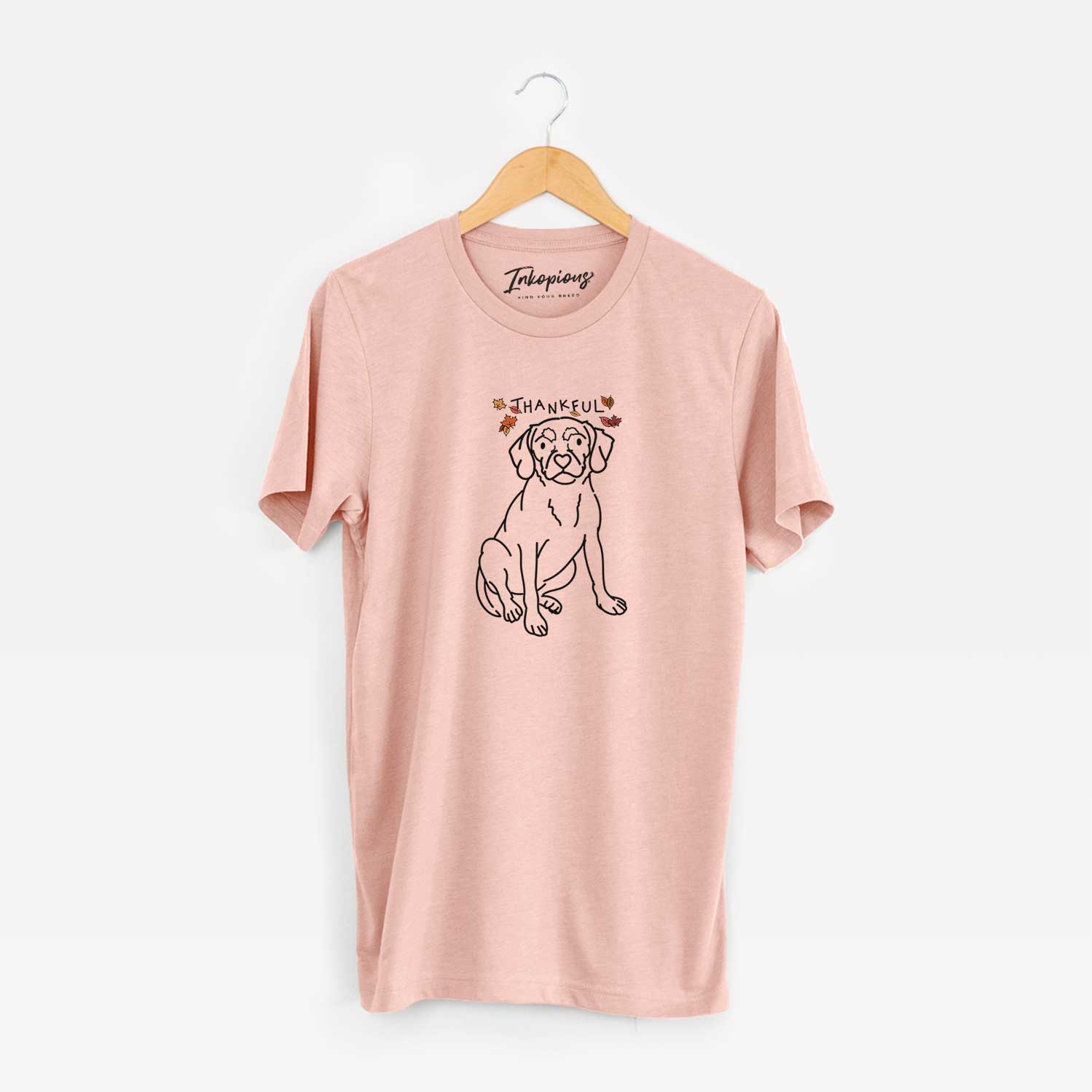 Minimalist line drawing of Babs the Puggle with 'Thankful' lettering on a Peach Unisex crewneck
