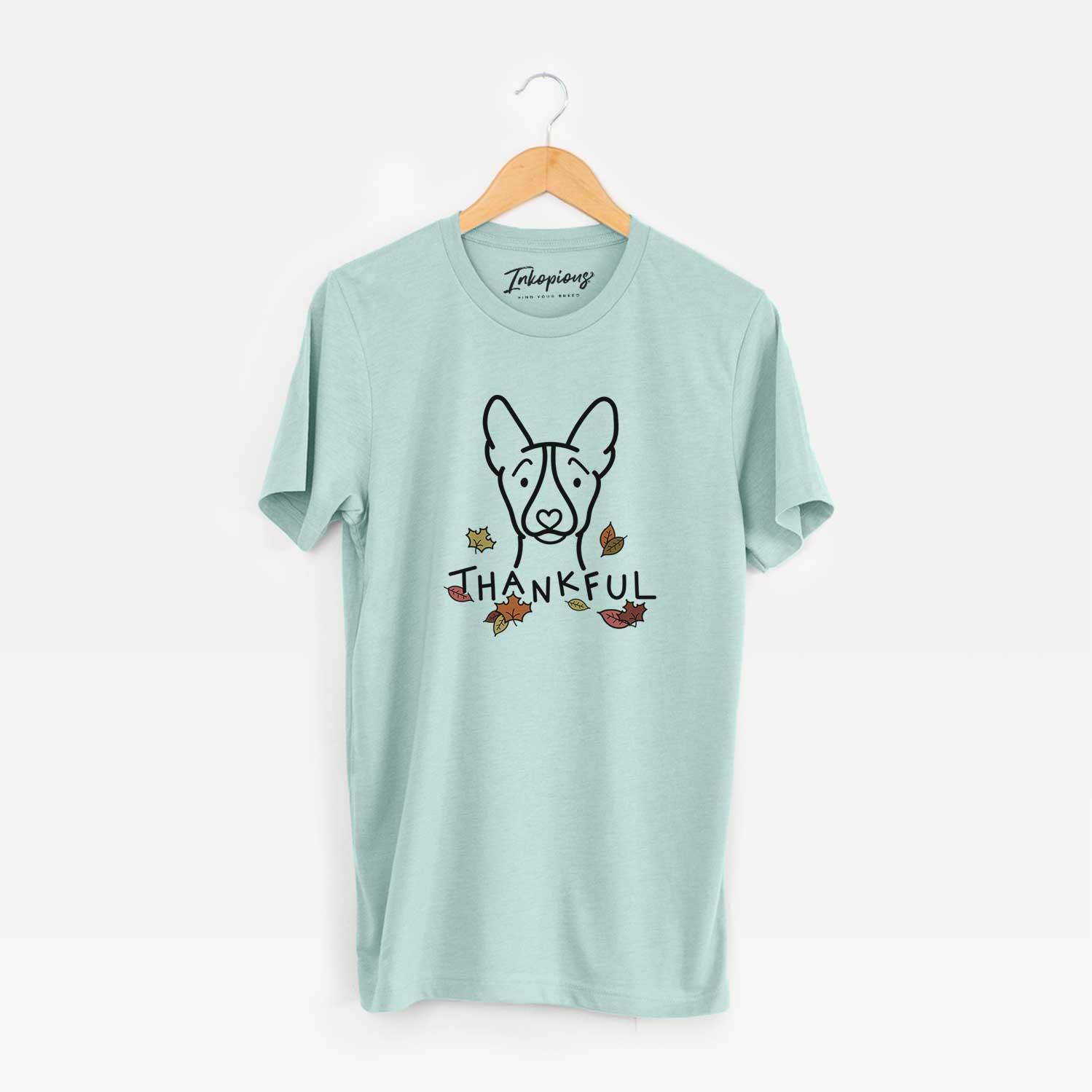 Minimalist line drawing of a Basenji with 'Thankful' lettering on a Heather Sage Unisex crewneck
