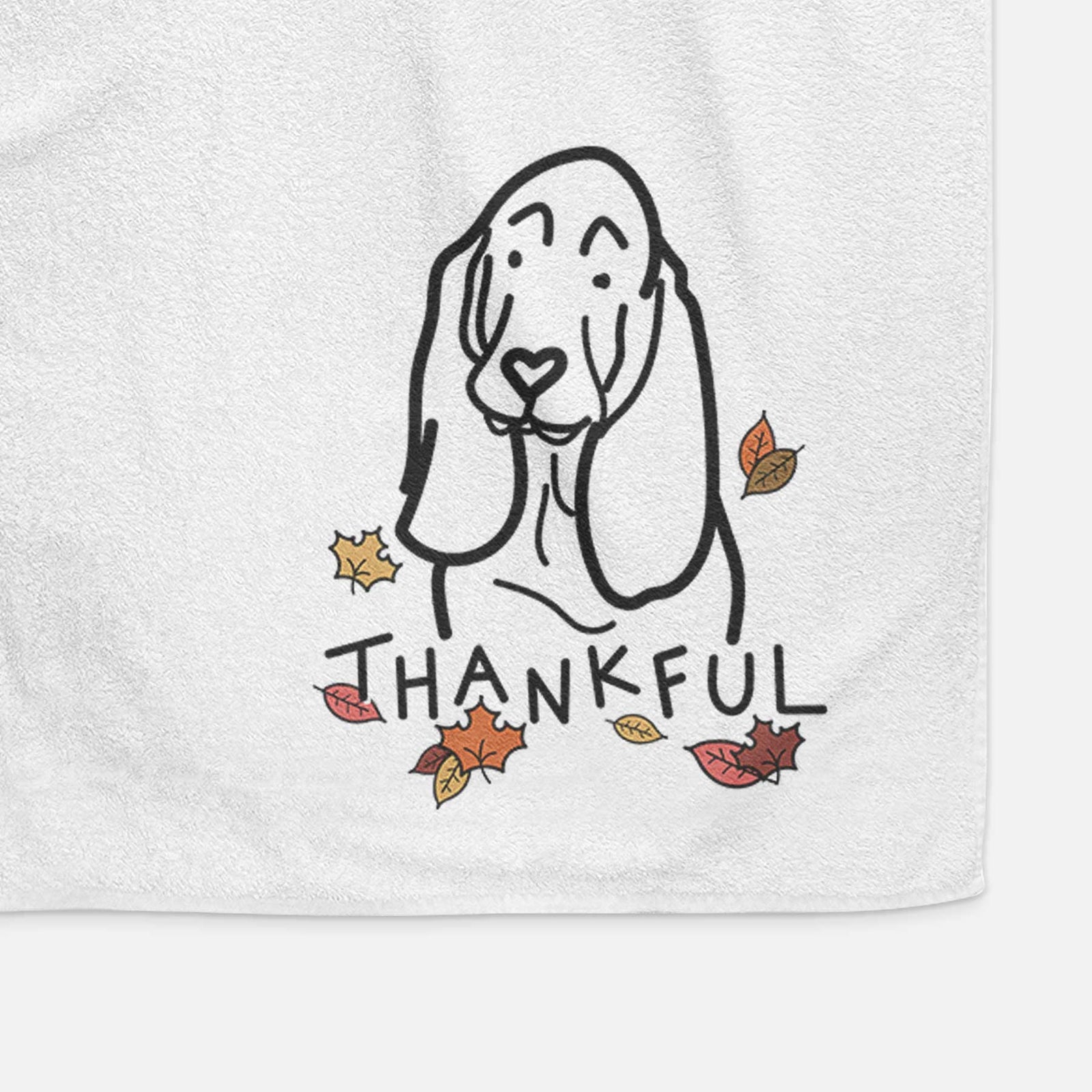 Minimalist line drawing of a Basset Hound with 'Thankful' lettering on a decorative hand towel