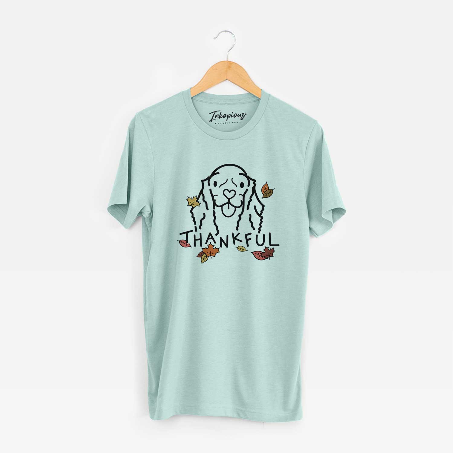 Minimalist line drawing of Bella the American Cocker Spaniel with 'Thankful' lettering on a Heather Sage Unisex crewneck