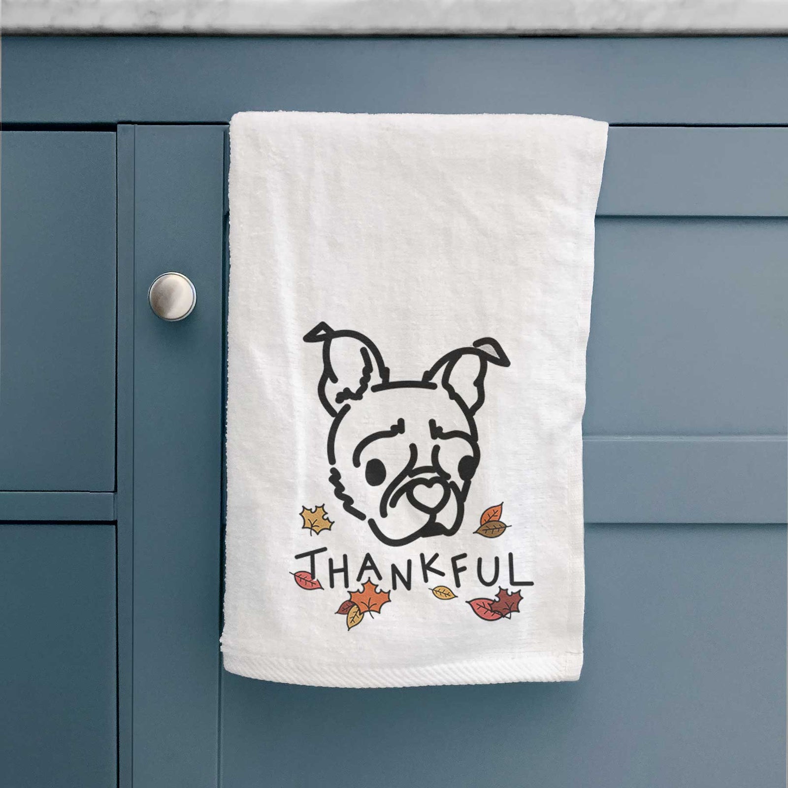 Minimalist line drawing of Bella the Pug Boston Terrier Mix with 'Thankful' lettering on a decorative hand towel