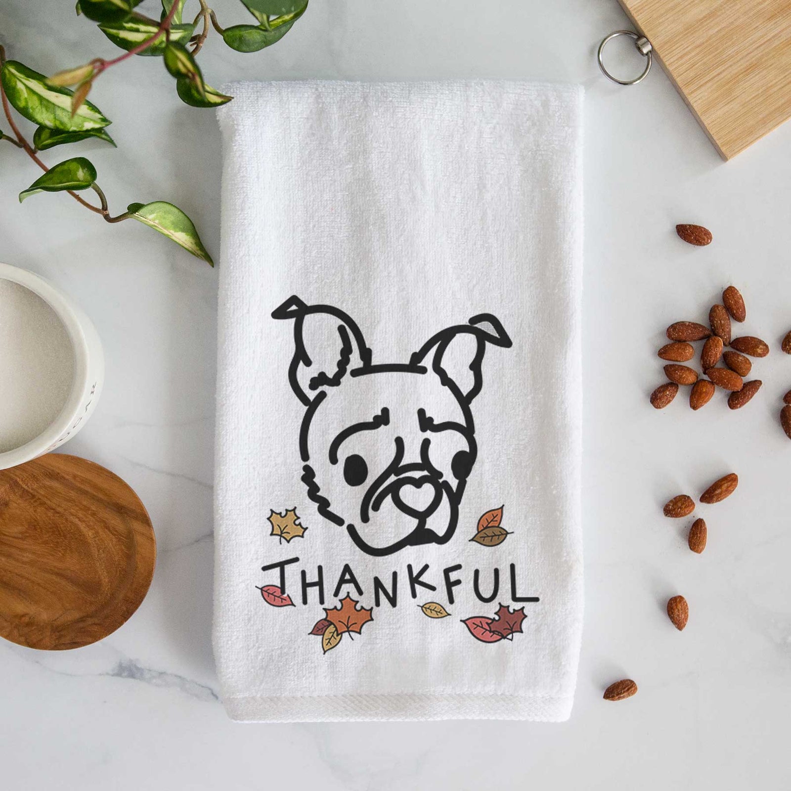 Minimalist line drawing of Bella the Pug Boston Terrier Mix with 'Thankful' lettering on a decorative hand towel