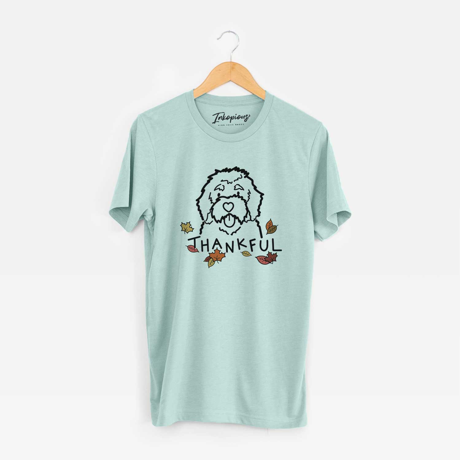 Minimalist line drawing of a Bernedoodle with 'Thankful' lettering on a Heather Sage Unisex crewneck