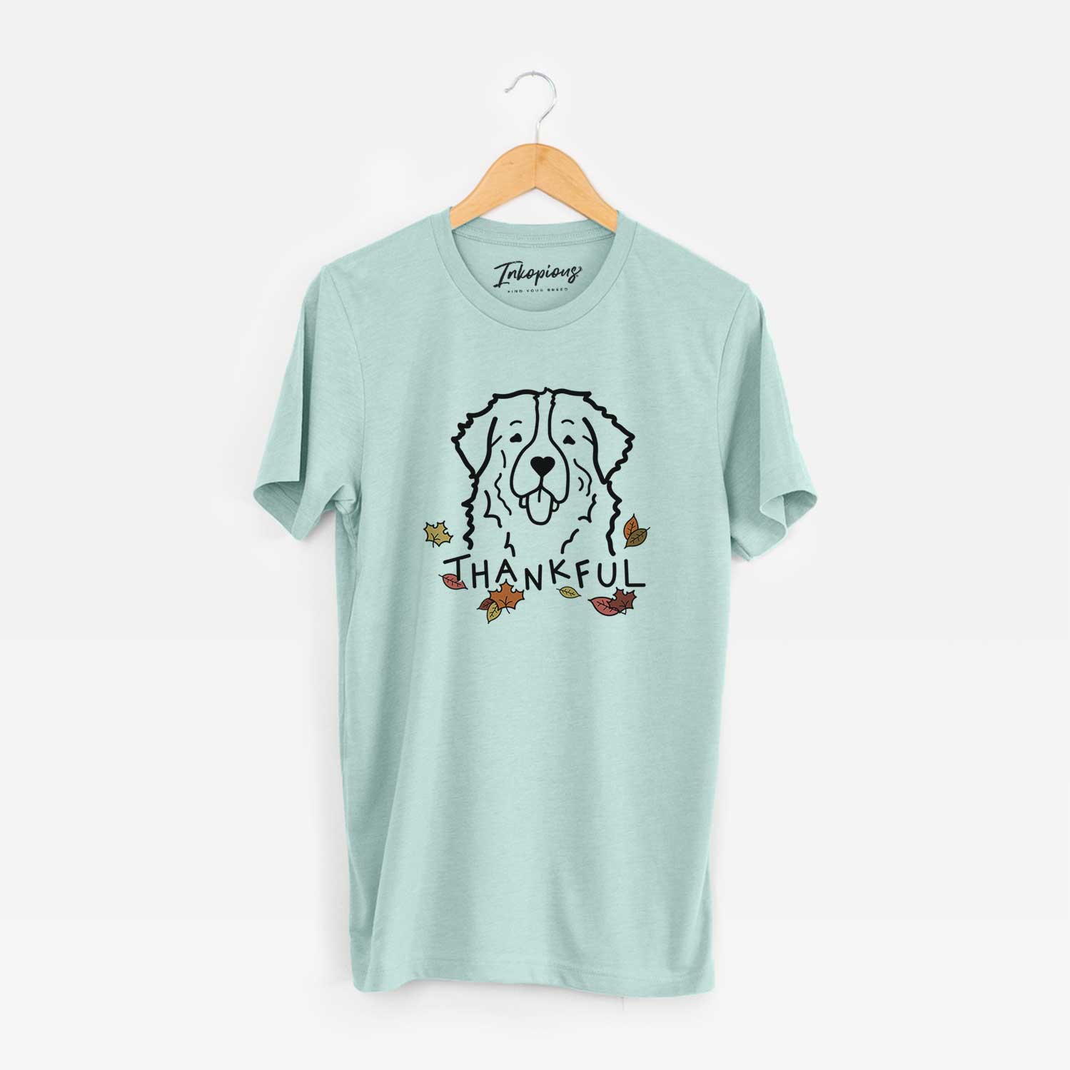 Minimalist line drawing of a Bernese Mountain Dog with 'Thankful' lettering on a Heather Sage Unisex crewneck