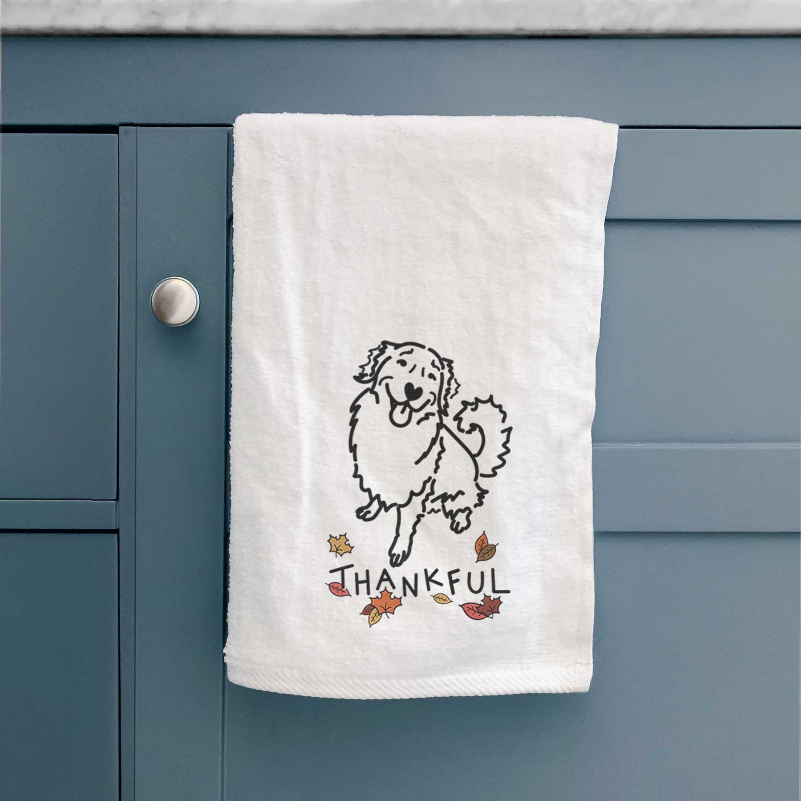 Minimalist line drawing of Brinkley the Golden Retriever with 'Thankful' lettering on a decorative hand towel