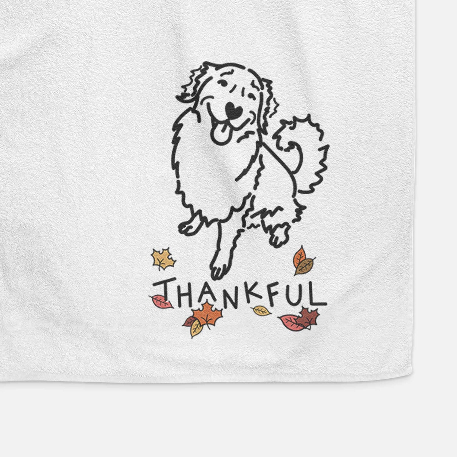 Minimalist line drawing of Brinkley the Golden Retriever with 'Thankful' lettering on a decorative hand towel