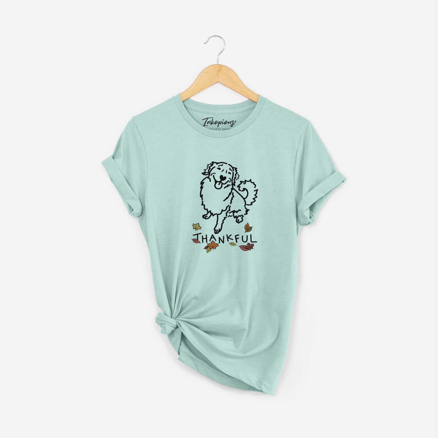 Minimalist line drawing of Brinkley the Golden Retriever with 'Thankful' lettering on a Heather Sage Unisex crewneck
