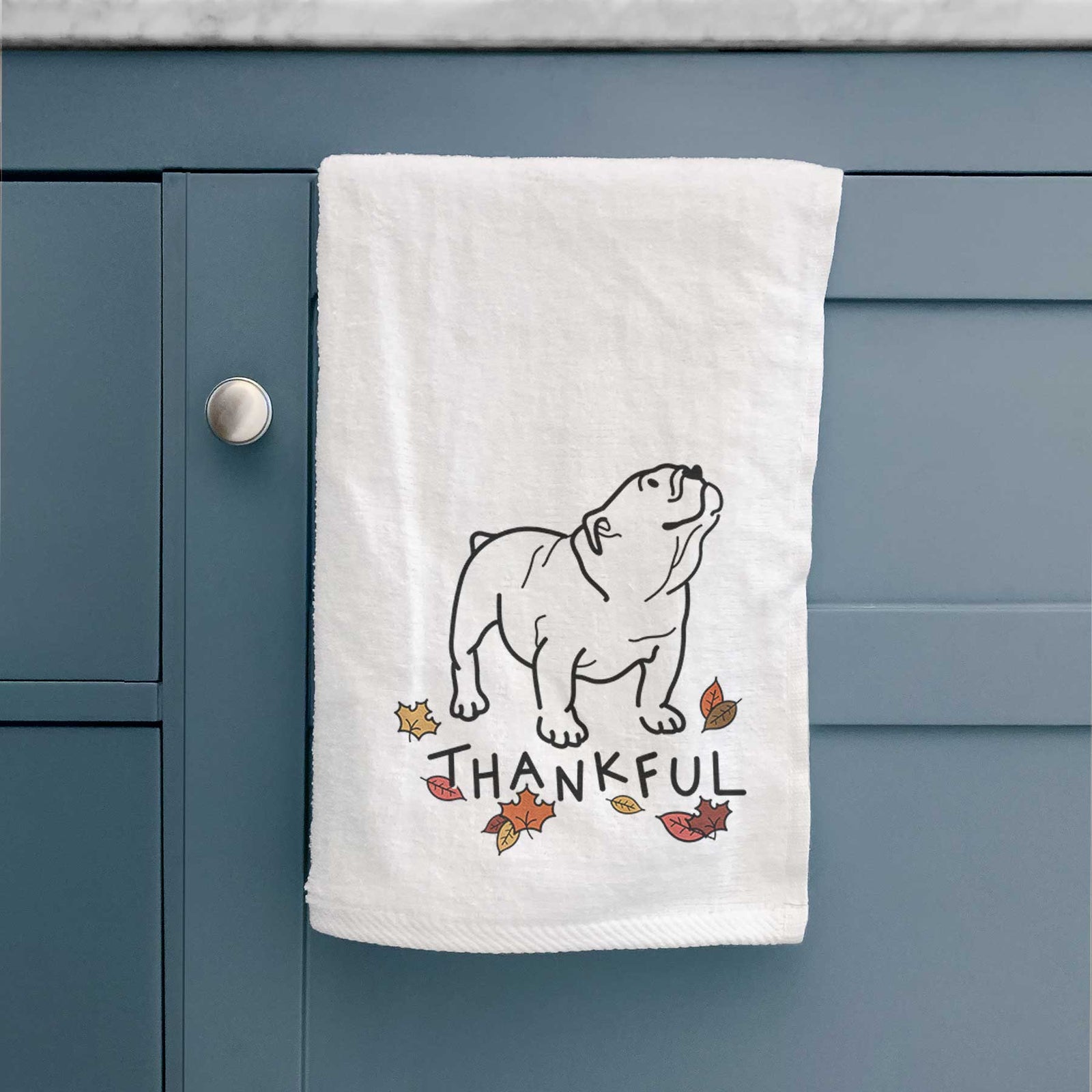 Minimalist line drawing of Bruno the English Bulldog with 'Thankful' lettering on a decorative hand towel