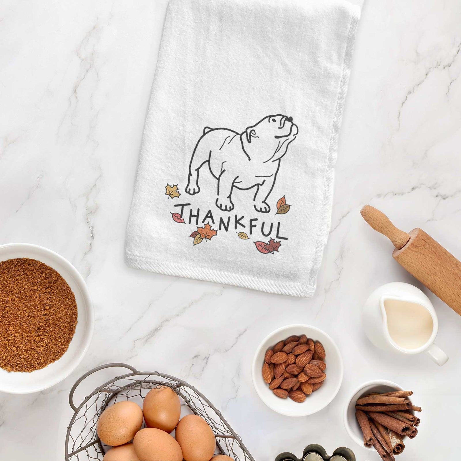 Minimalist line drawing of Bruno the English Bulldog with 'Thankful' lettering on a decorative hand towel
