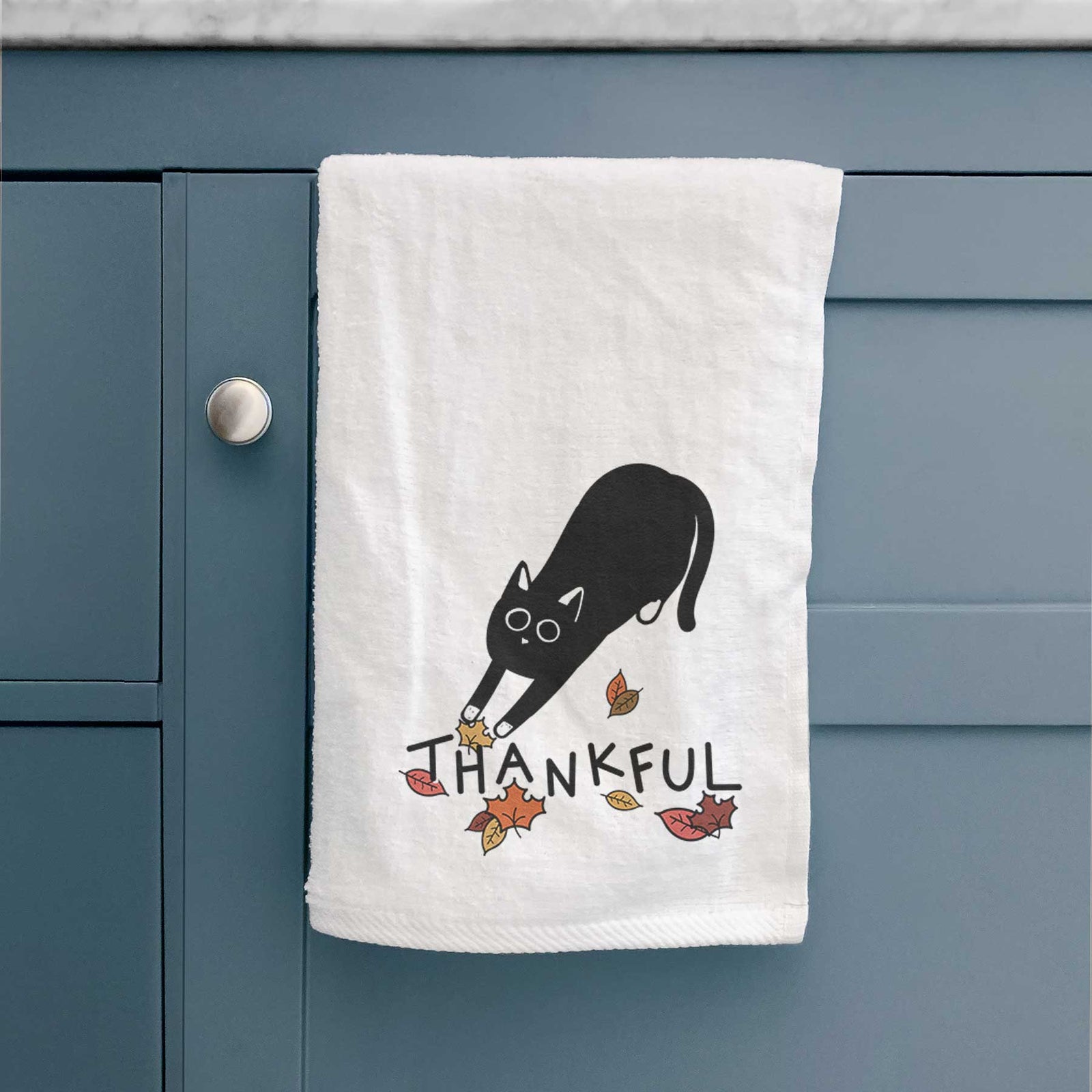 Minimalist line drawing of Bug the Black Cat with 'Thankful' lettering on a decorative hand towel