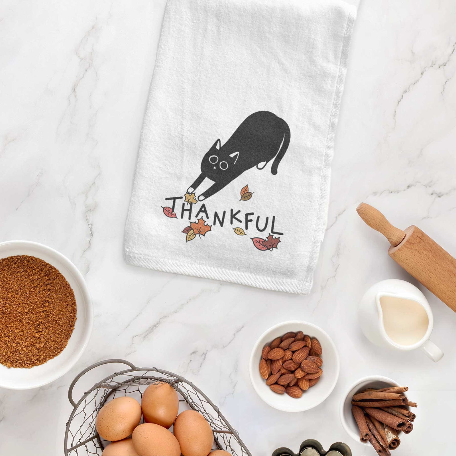 Minimalist line drawing of Bug the Black Cat with 'Thankful' lettering on a decorative hand towel