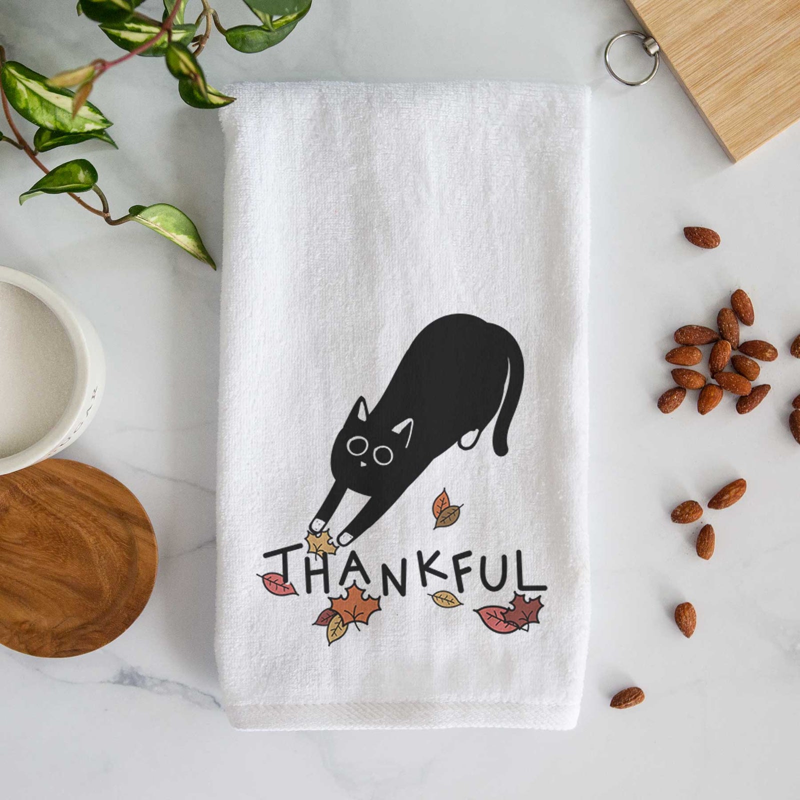 Minimalist line drawing of Bug the Black Cat with 'Thankful' lettering on a decorative hand towel