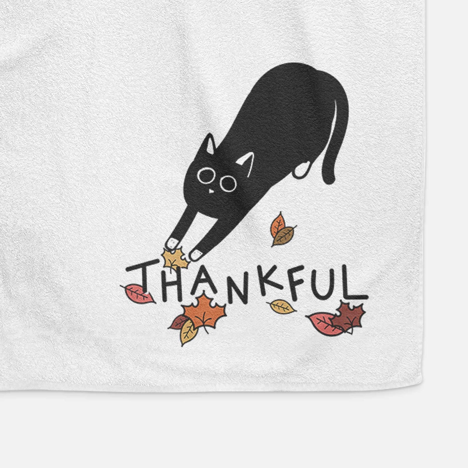 Minimalist line drawing of Bug the Black Cat with 'Thankful' lettering on a decorative hand towel