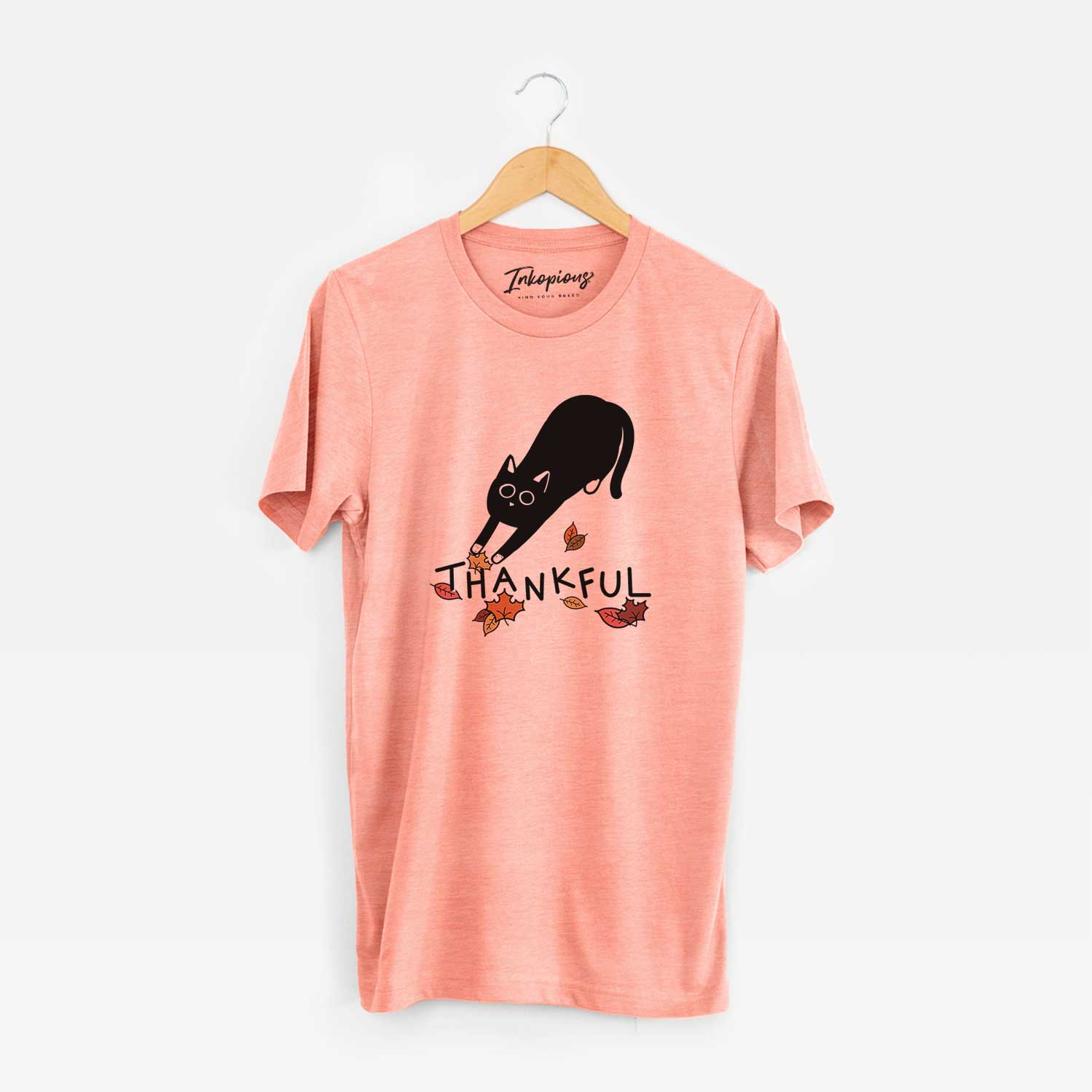 Minimalist line drawing of Bug the Black Cat with 'Thankful' lettering on a Sunset Unisex crewneck