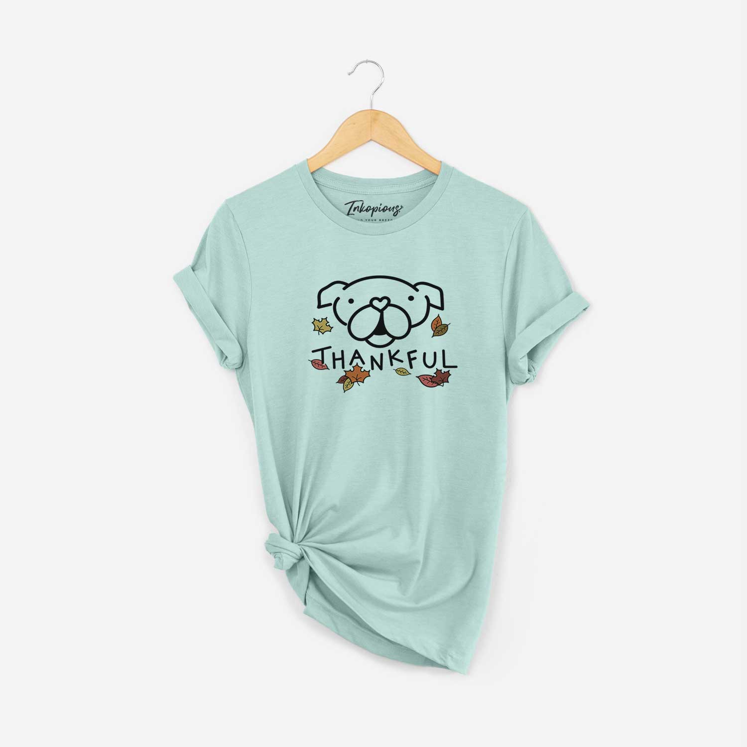 Minimalist line drawing of an English Bulldog with 'Thankful' lettering on a Heather Sage Unisex crewneck