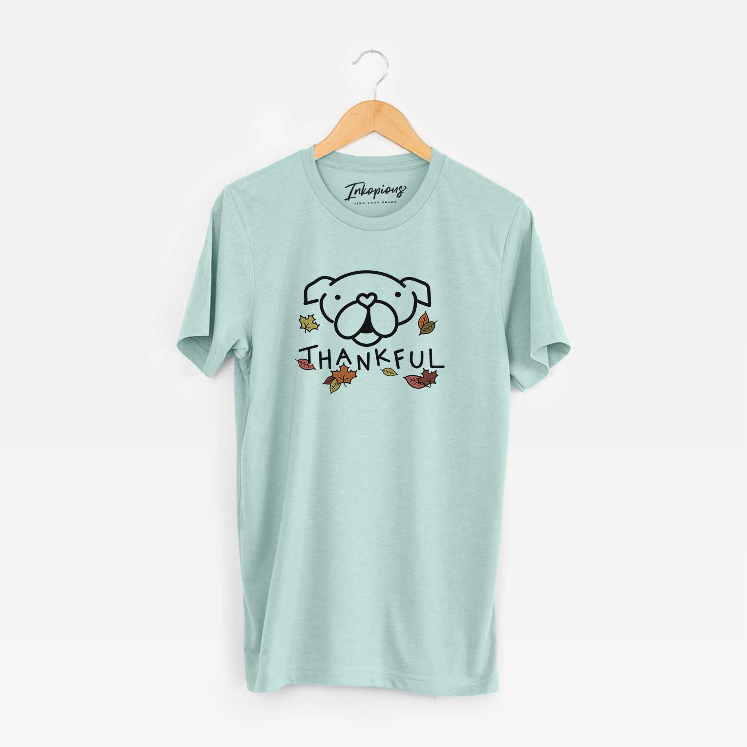 Minimalist line drawing of an English Bulldog with 'Thankful' lettering on a Heather Sage Unisex crewneck