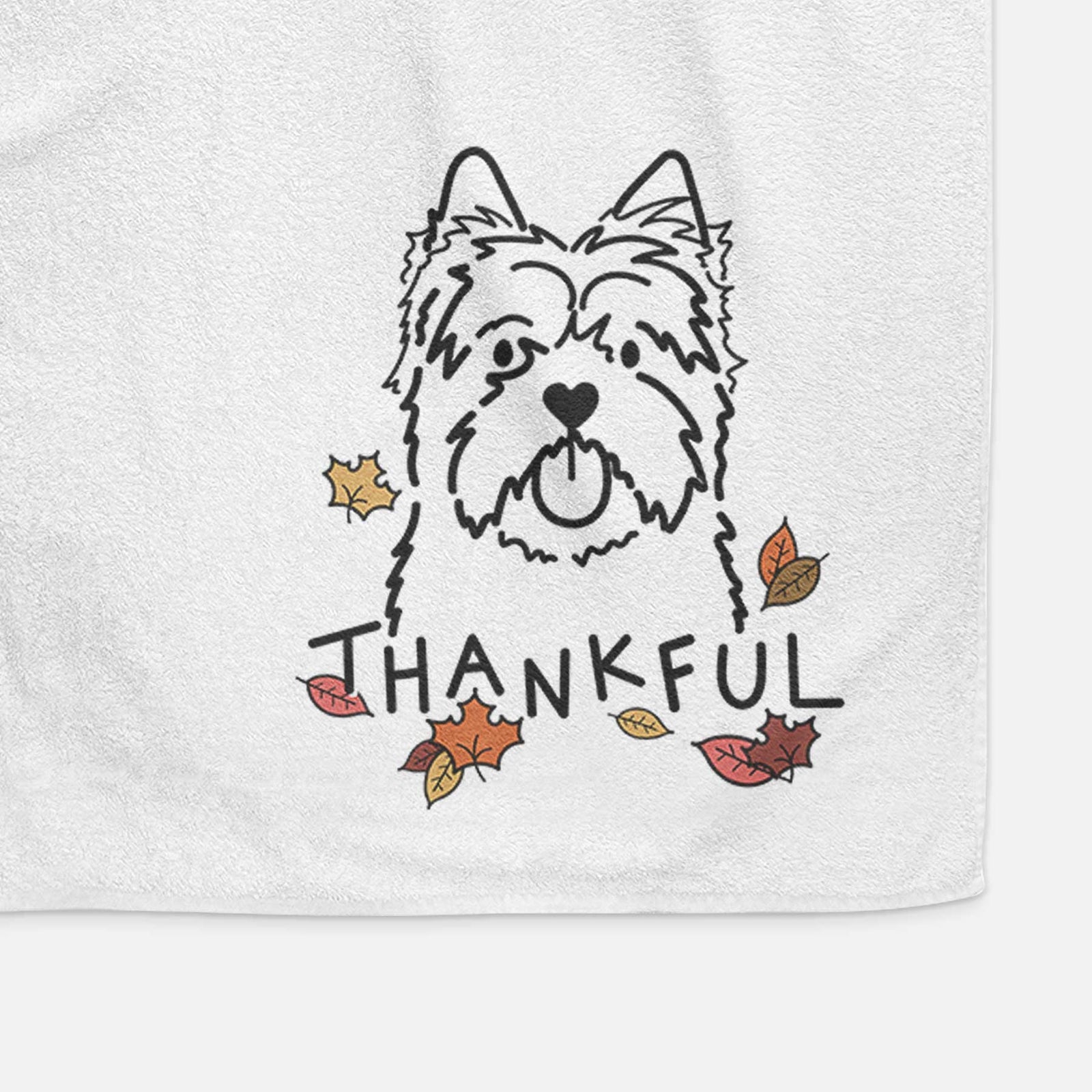 Minimalist line drawing of a Cairn Terrier with 'Thankful' lettering on a decorative hand towel
