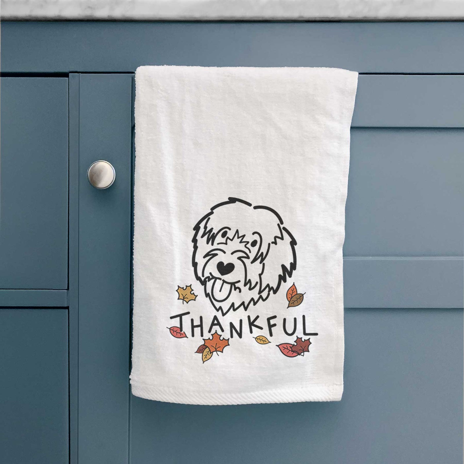 Minimalist line drawing of a Catalan Sheepdog with 'Thankful' lettering on a decorative hand towel