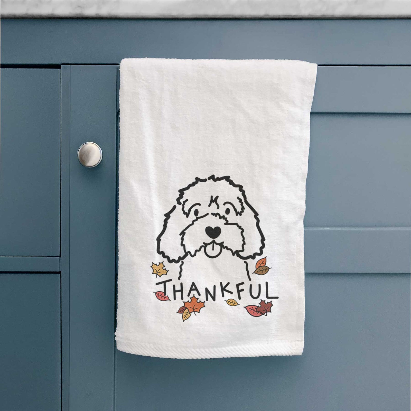 Minimalist line drawing of a Cavapoo with 'Thankful' lettering on a decorative hand towel