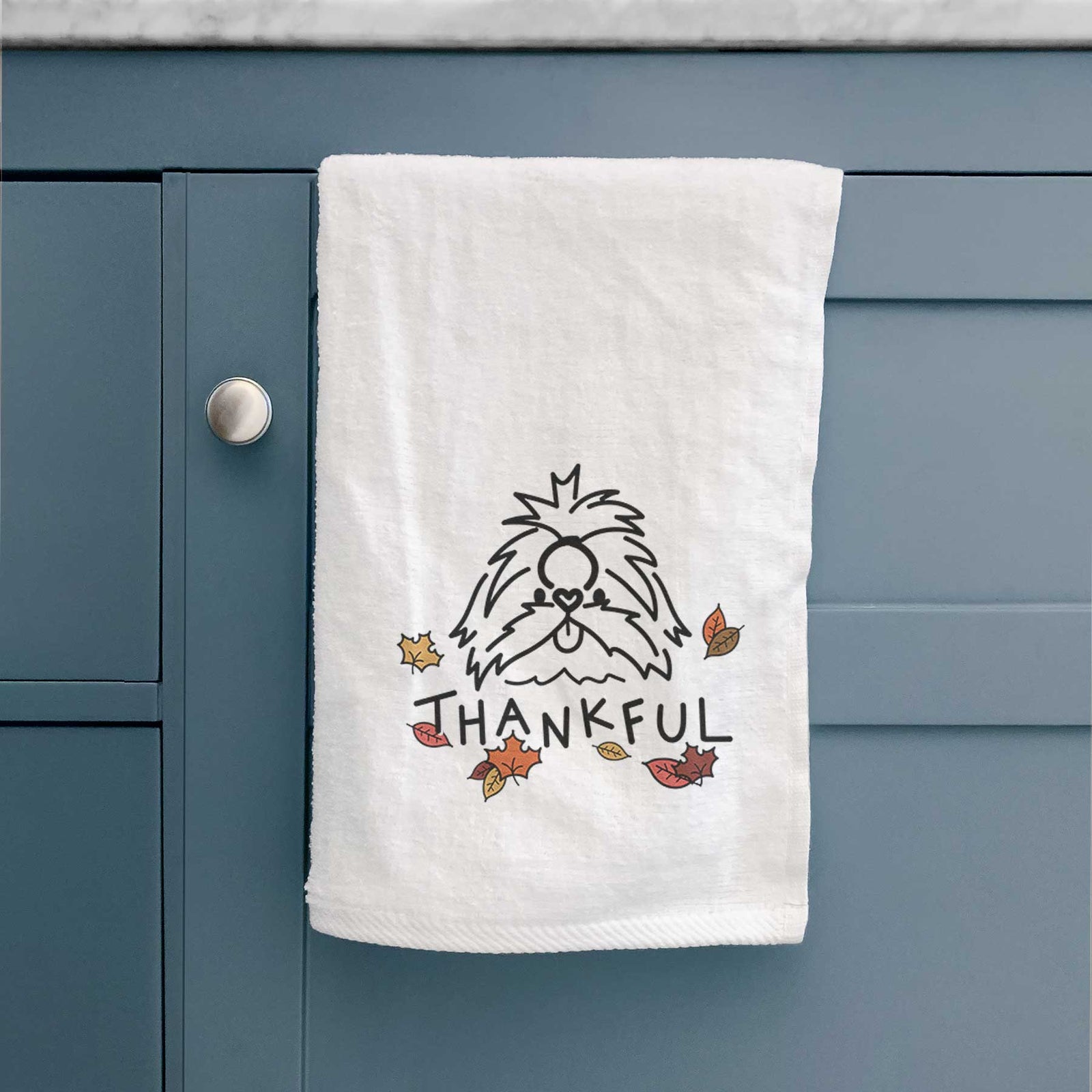 Minimalist line drawing of CoCo the Shih Tzu with 'Thankful' lettering on a decorative hand towel