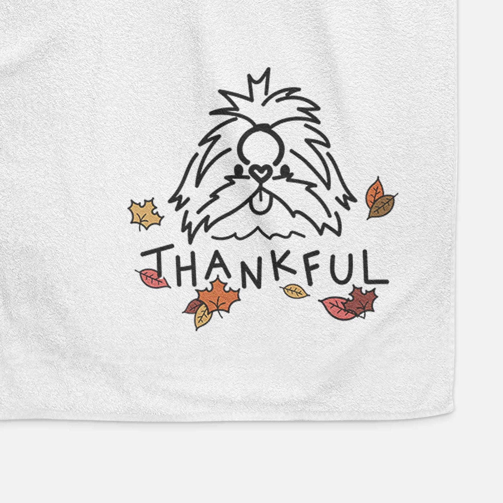 Minimalist line drawing of CoCo the Shih Tzu with 'Thankful' lettering on a decorative hand towel