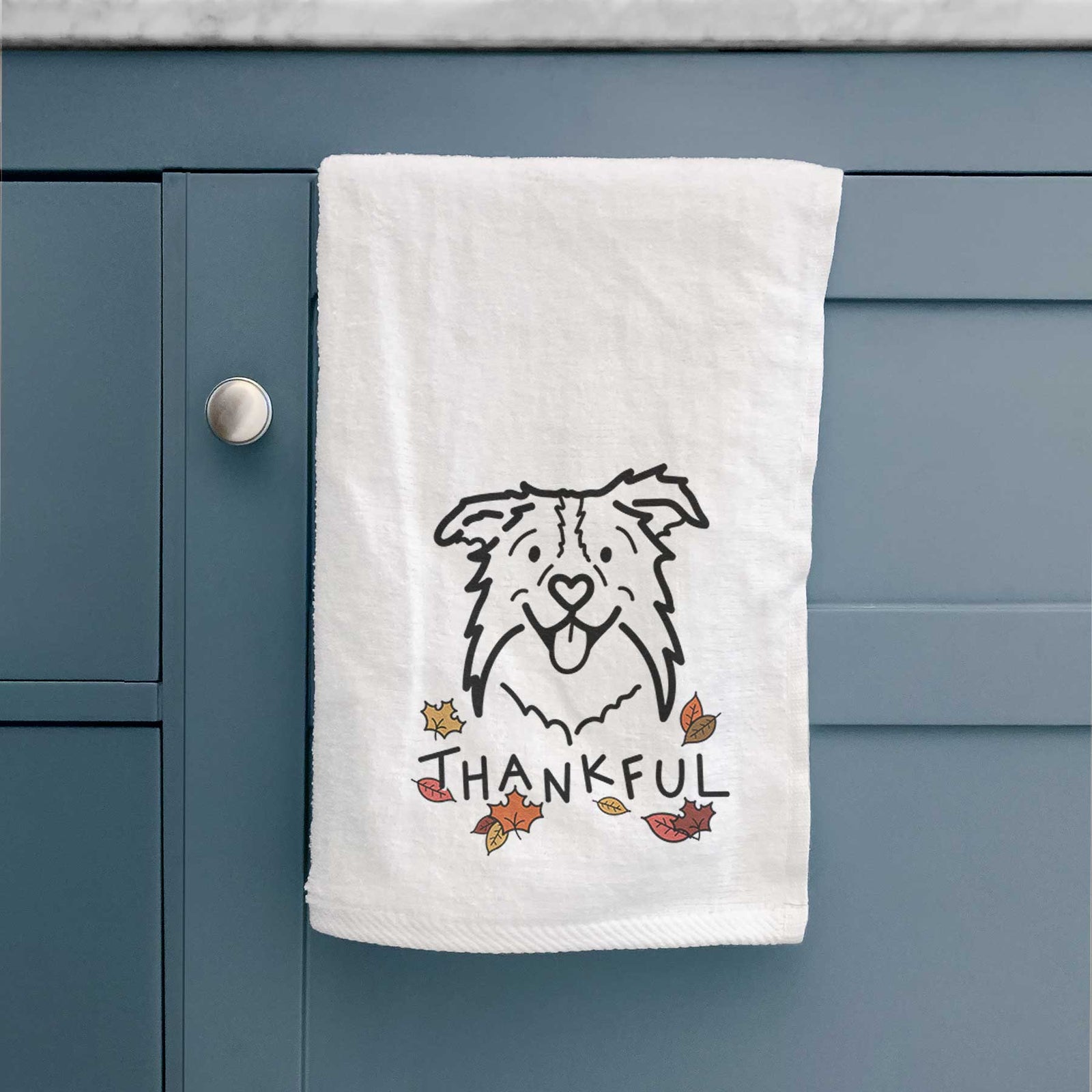 Minimalist line drawing of Cricket the Border Collie with 'Thankful' lettering on a decorative hand towel