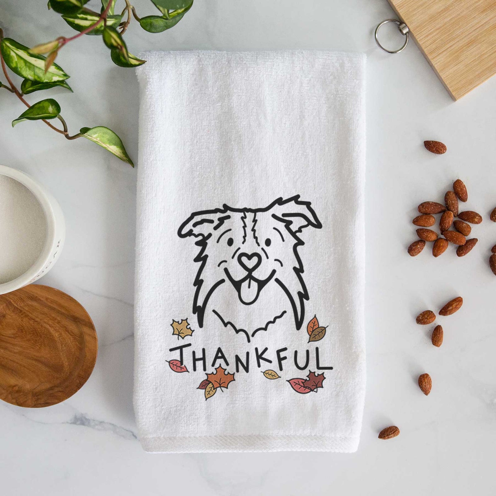Minimalist line drawing of Cricket the Border Collie with 'Thankful' lettering on a decorative hand towel