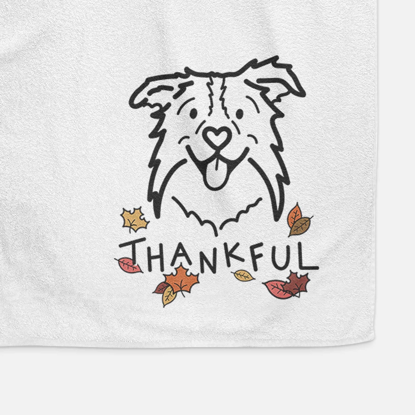 Minimalist line drawing of Cricket the Border Collie with 'Thankful' lettering on a decorative hand towel