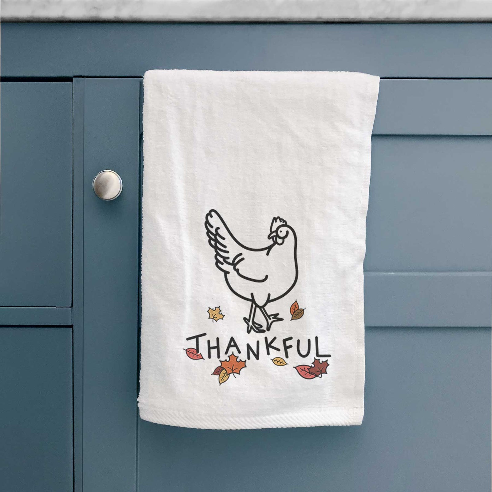 Minimalist line drawing of Daisy the Chicken with 'Thankful' lettering on a decorative hand towel