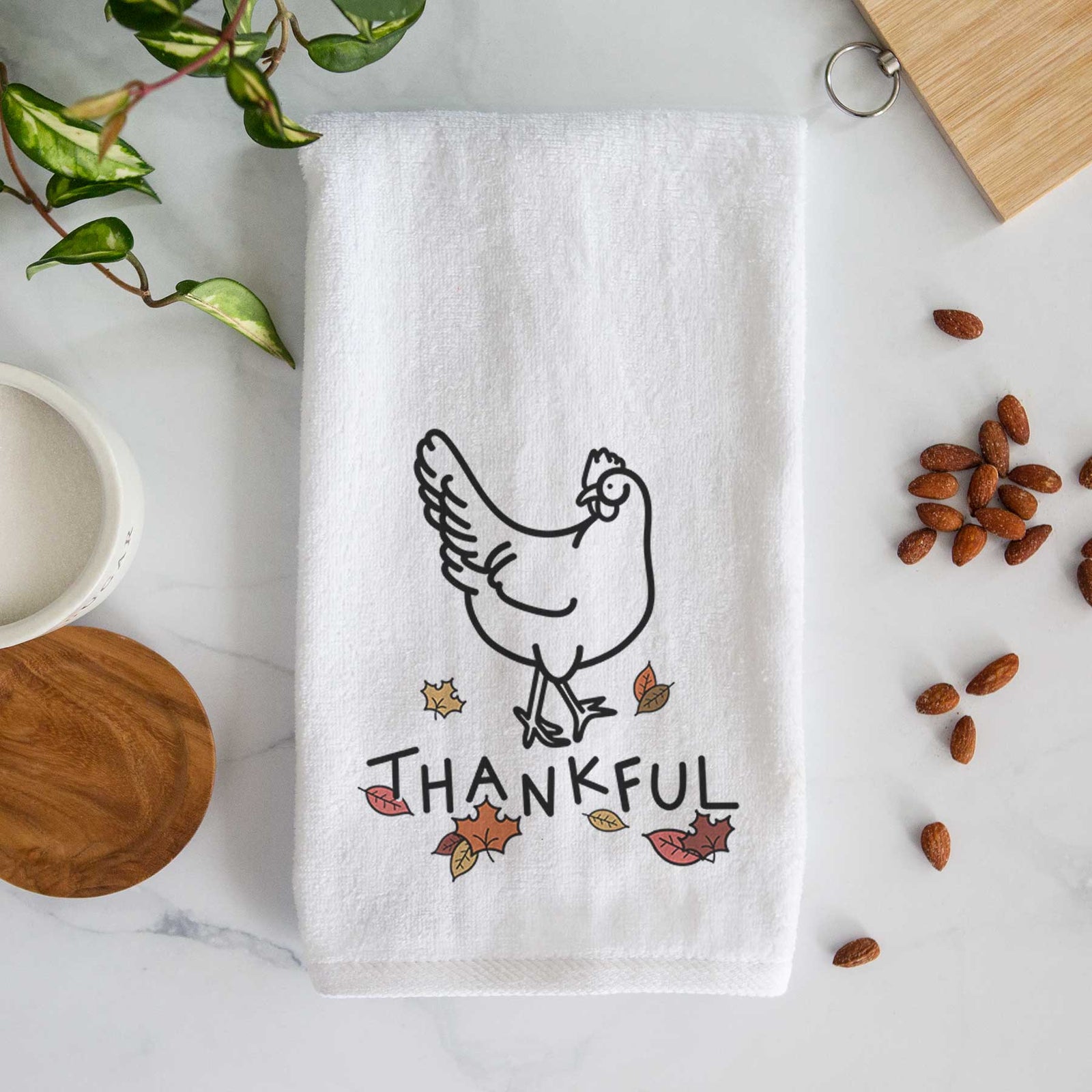 Minimalist line drawing of Daisy the Chicken with 'Thankful' lettering on a decorative hand towel