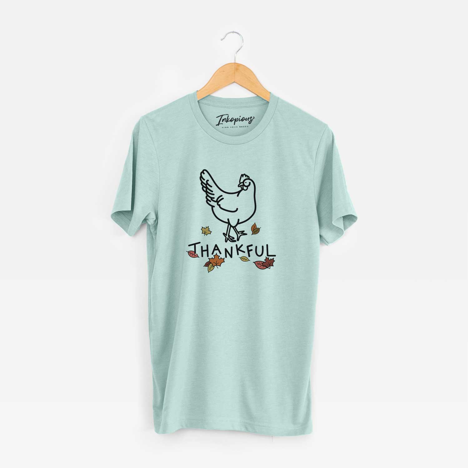 Minimalist line drawing of Daisy the Chicken with 'Thankful' lettering on a Heather Sage Unisex crewneck