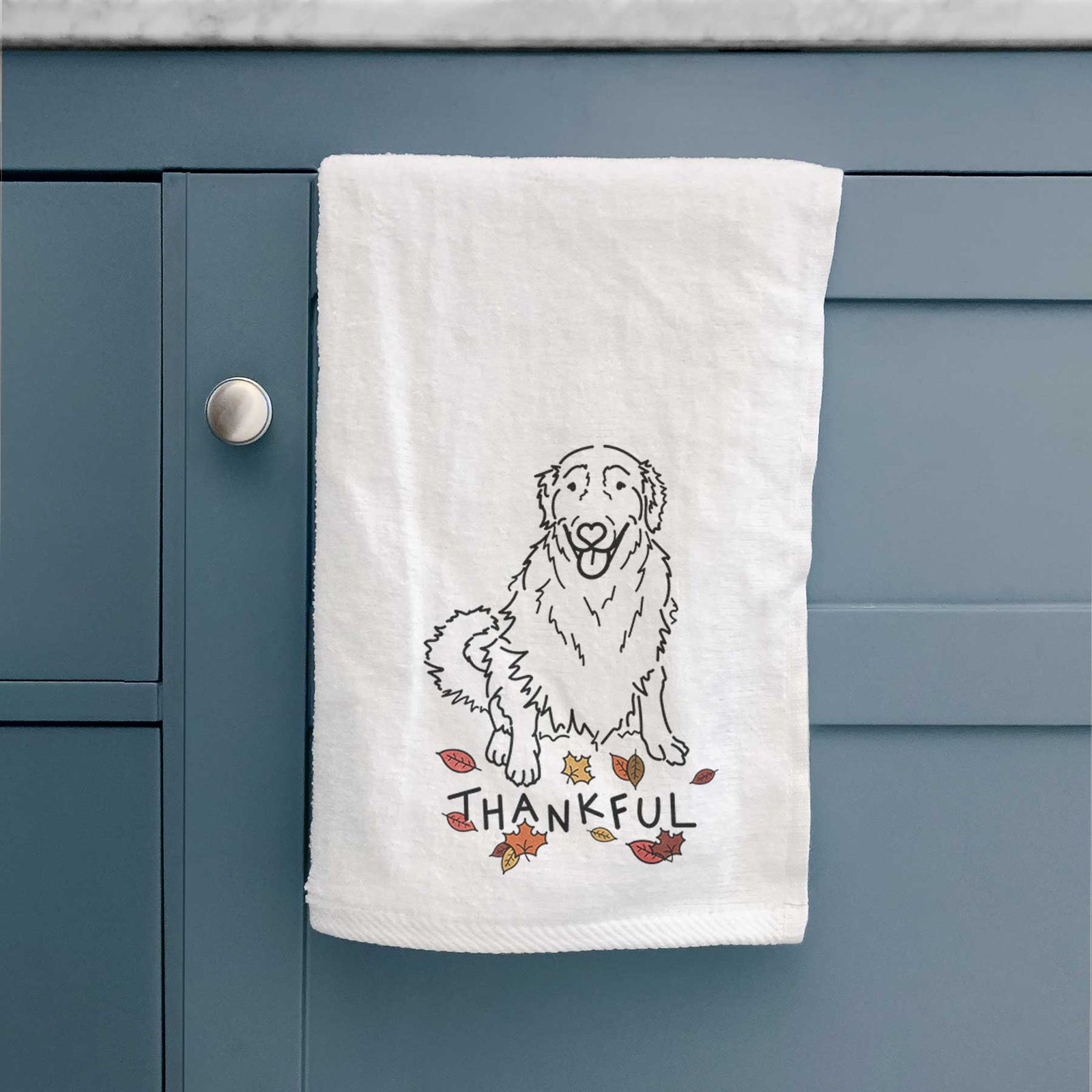 Minimalist line drawing of Daisy the Golden Retriever with 'Thankful' lettering on a decorative hand towel