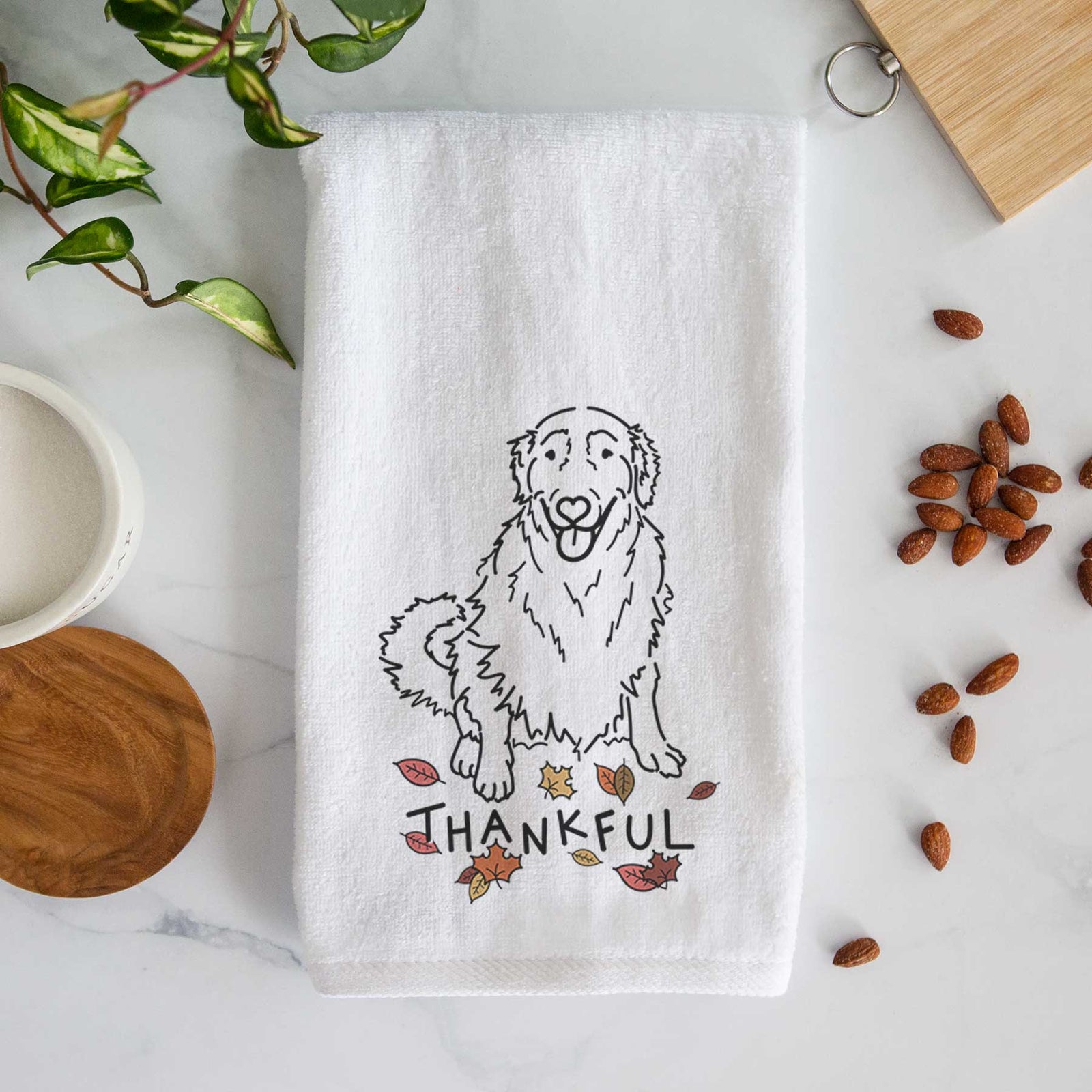 Minimalist line drawing of Daisy the Golden Retriever with 'Thankful' lettering on a decorative hand towel