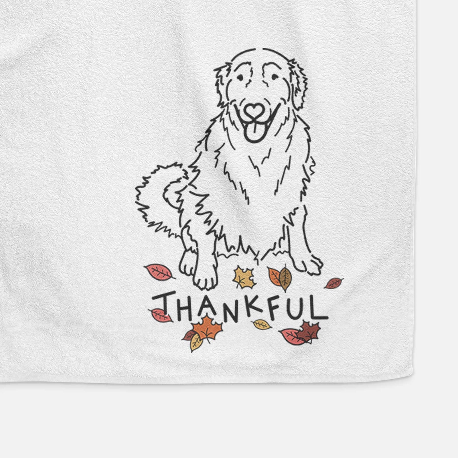 Minimalist line drawing of Daisy the Golden Retriever with 'Thankful' lettering on a decorative hand towel