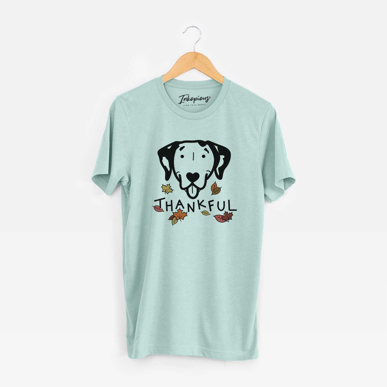 Minimalist line drawing of a Dalmatian with 'Thankful' lettering on a Heather Sage Unisex crewneck