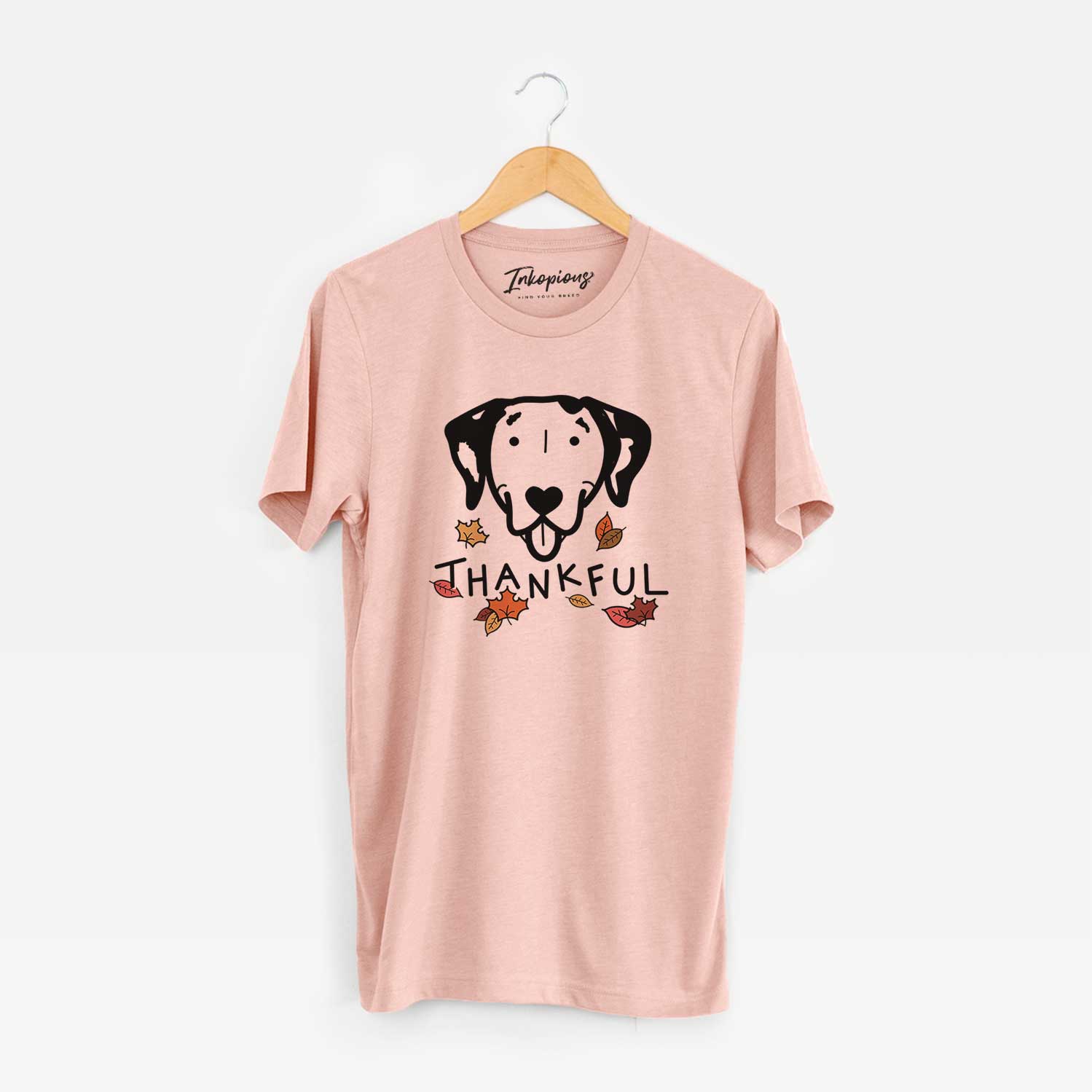 Minimalist line drawing of a Dalmatian with 'Thankful' lettering on a Peach Unisex crewneck