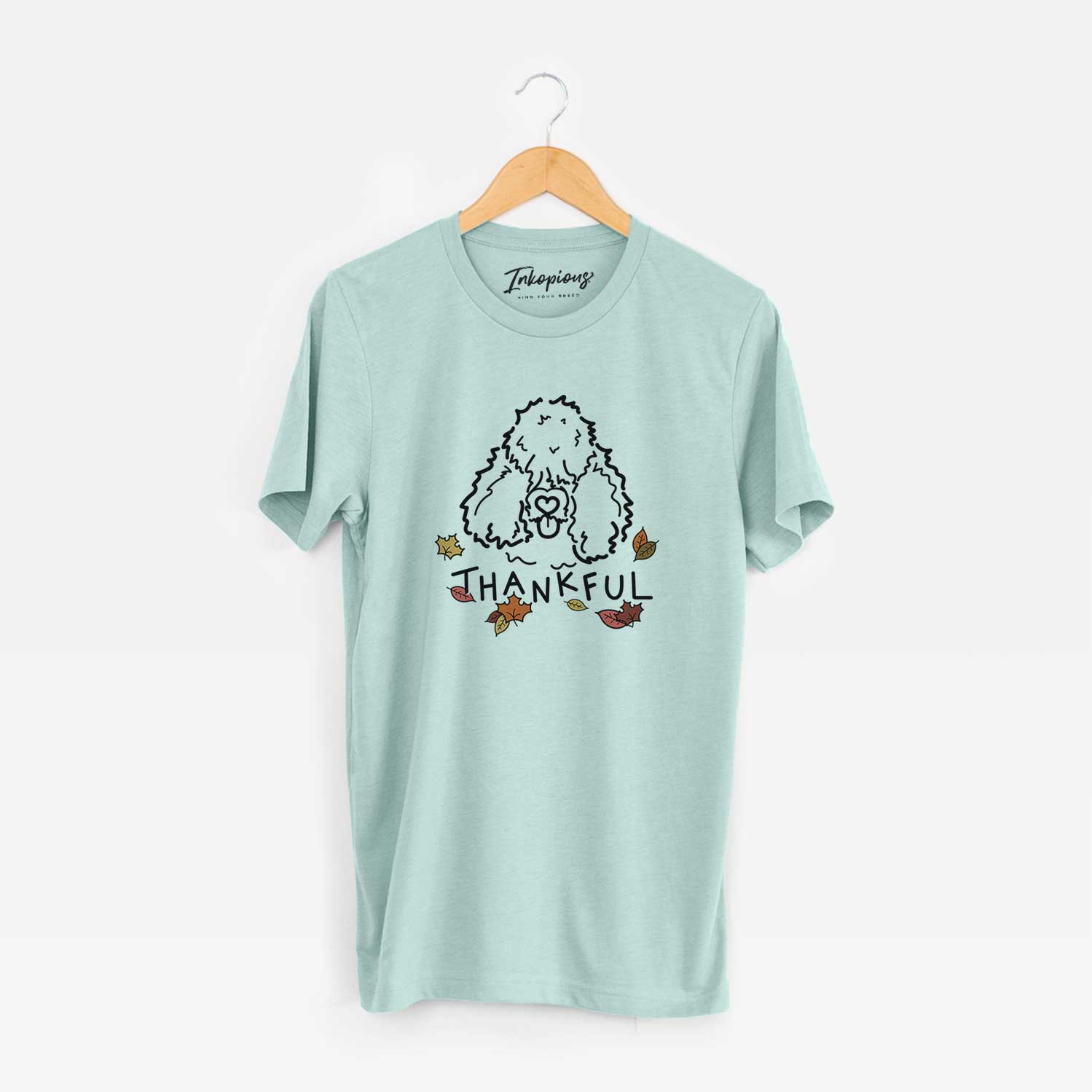Minimalist line drawing of Deeogey the Bouvier des Flandres with 'Thankful' lettering on a Heather Sage Unisex crewneck