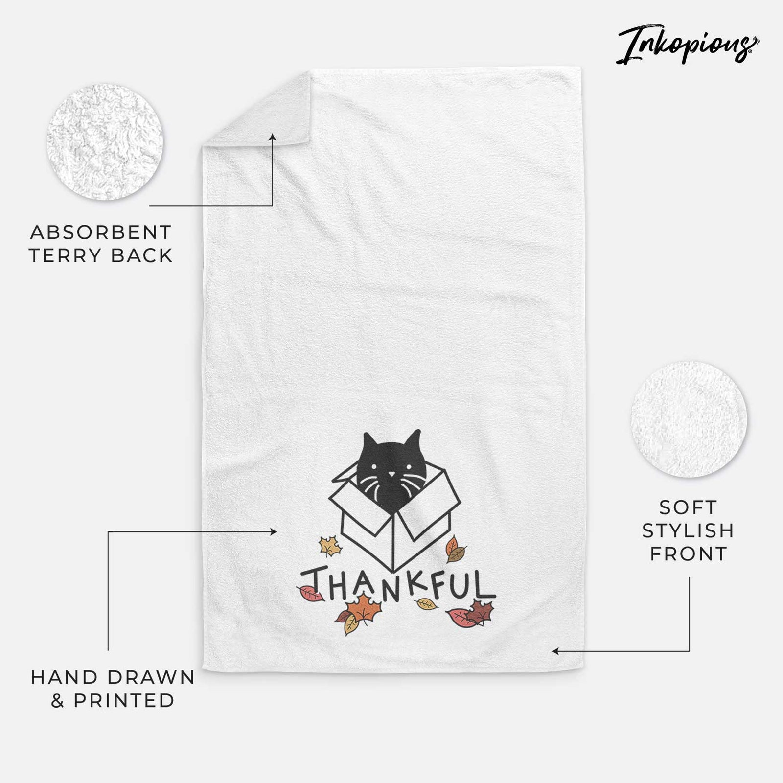Minimalist line drawing of Doc the Black Cat in a Box with 'Thankful' lettering on a decorative hand towel