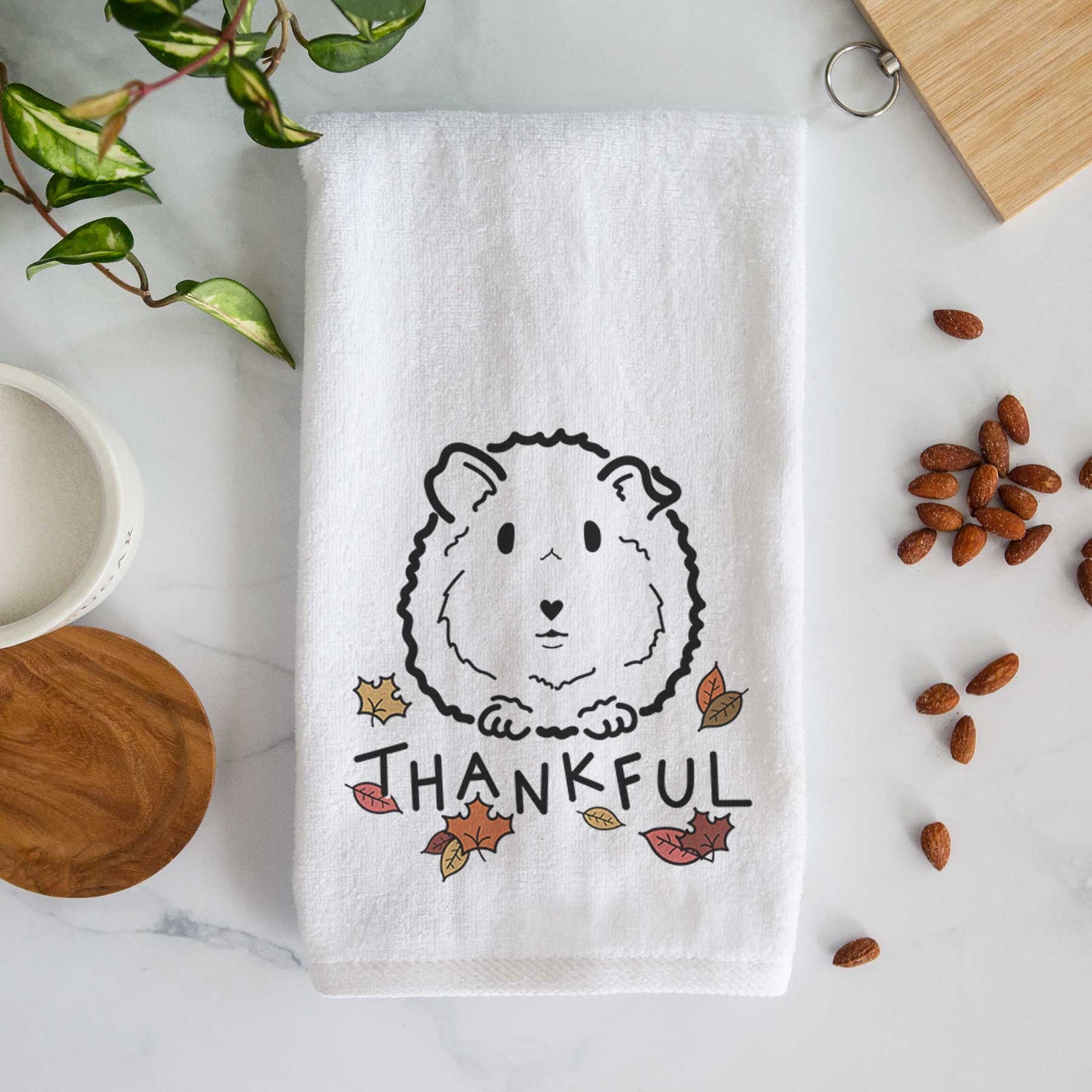 Minimalist line drawing of Duke the Guinea Pig with 'Thankful' lettering on a decorative hand towel