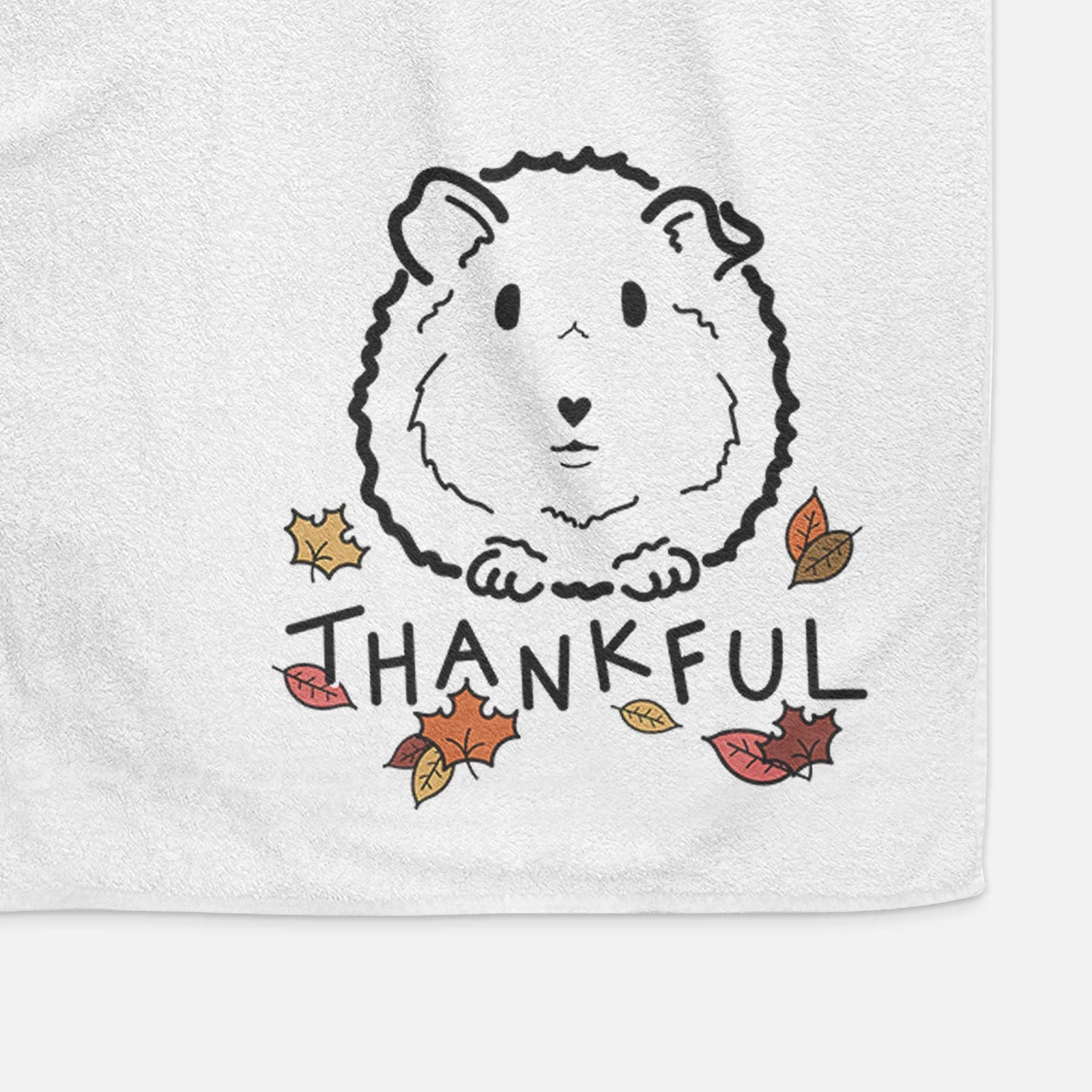 Minimalist line drawing of Duke the Guinea Pig with 'Thankful' lettering on a decorative hand towel